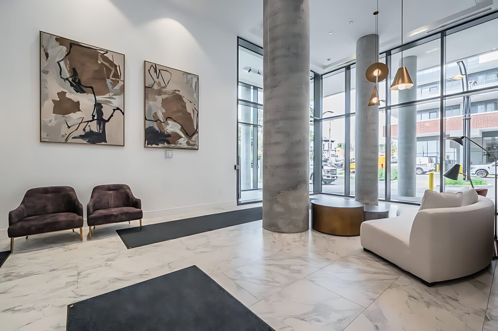 Elegant Lobby With Comfortable Seating And Contemporary Art Welcoming You To The Building