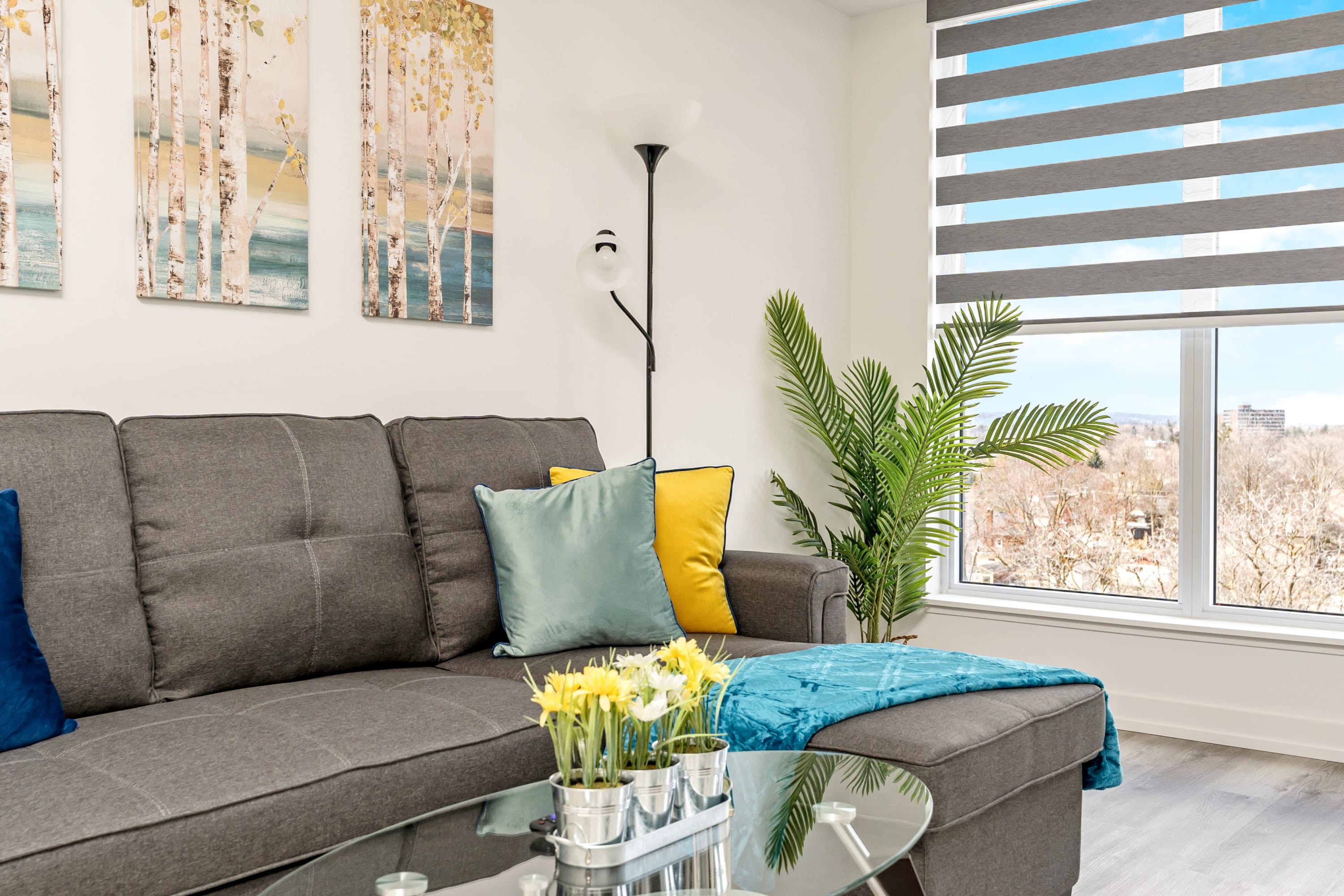 Living Area Highlighting Floor-To-Ceiling Windows Comfortable Seating And Direct Access To The Balcony