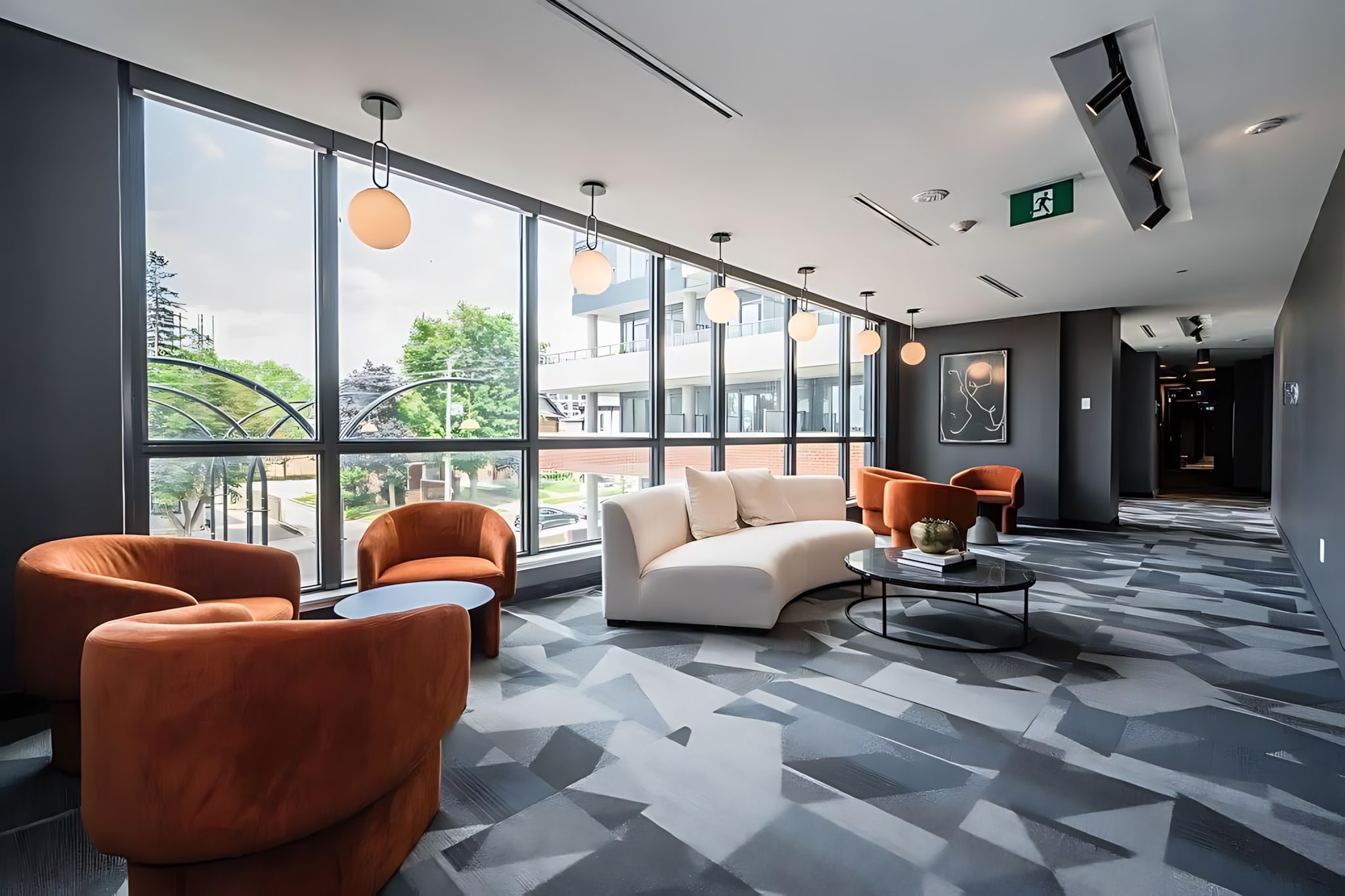 Bright Communal Lounge With Modern Furniture And Large Windows Creating A Perfect Space To Relax Or Socialize