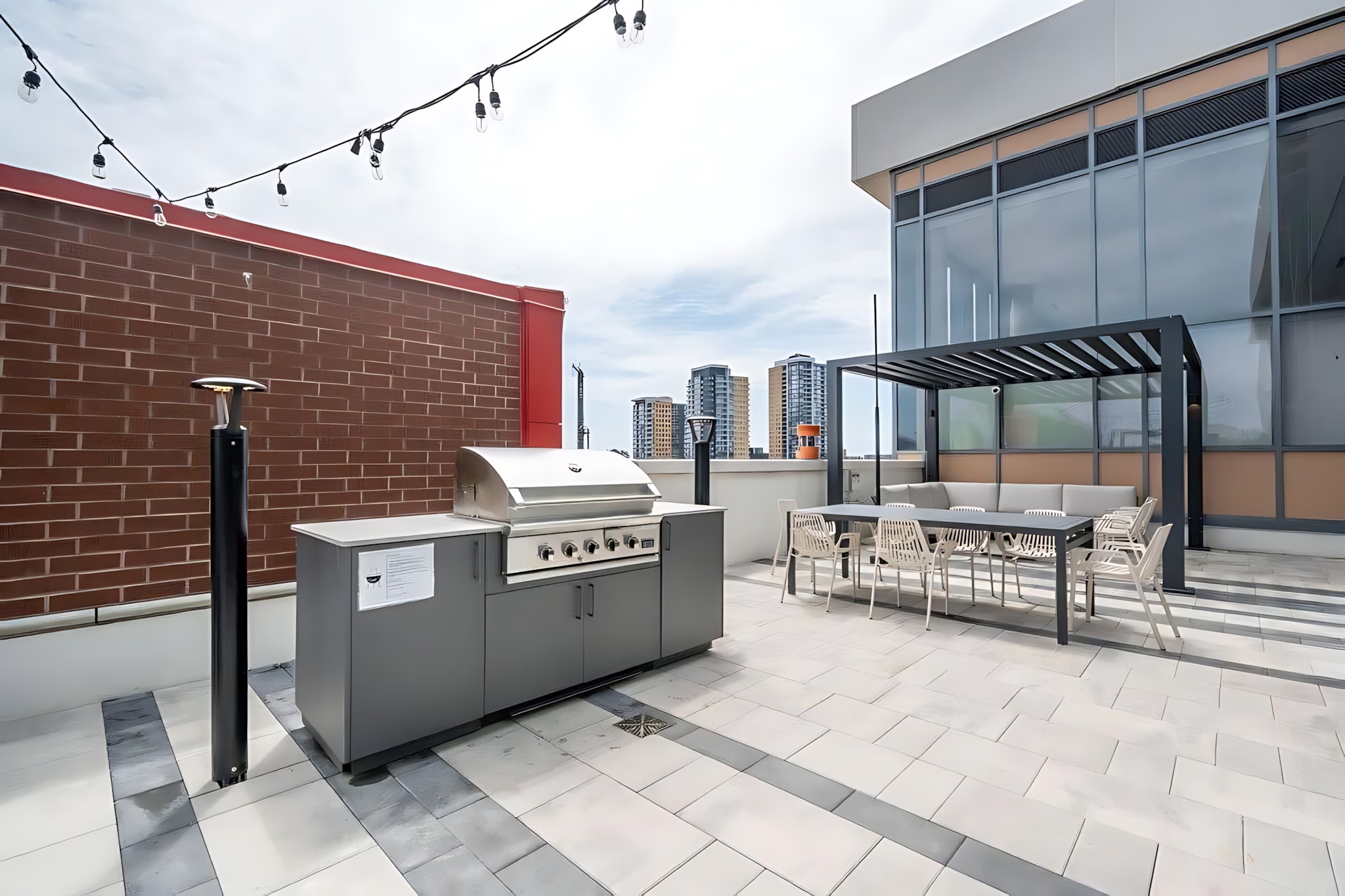 Rooftop Terrace With BBQ Stations And Ample Seating Ideal For Hosting Outdoor Meals And Enjoying City Views
