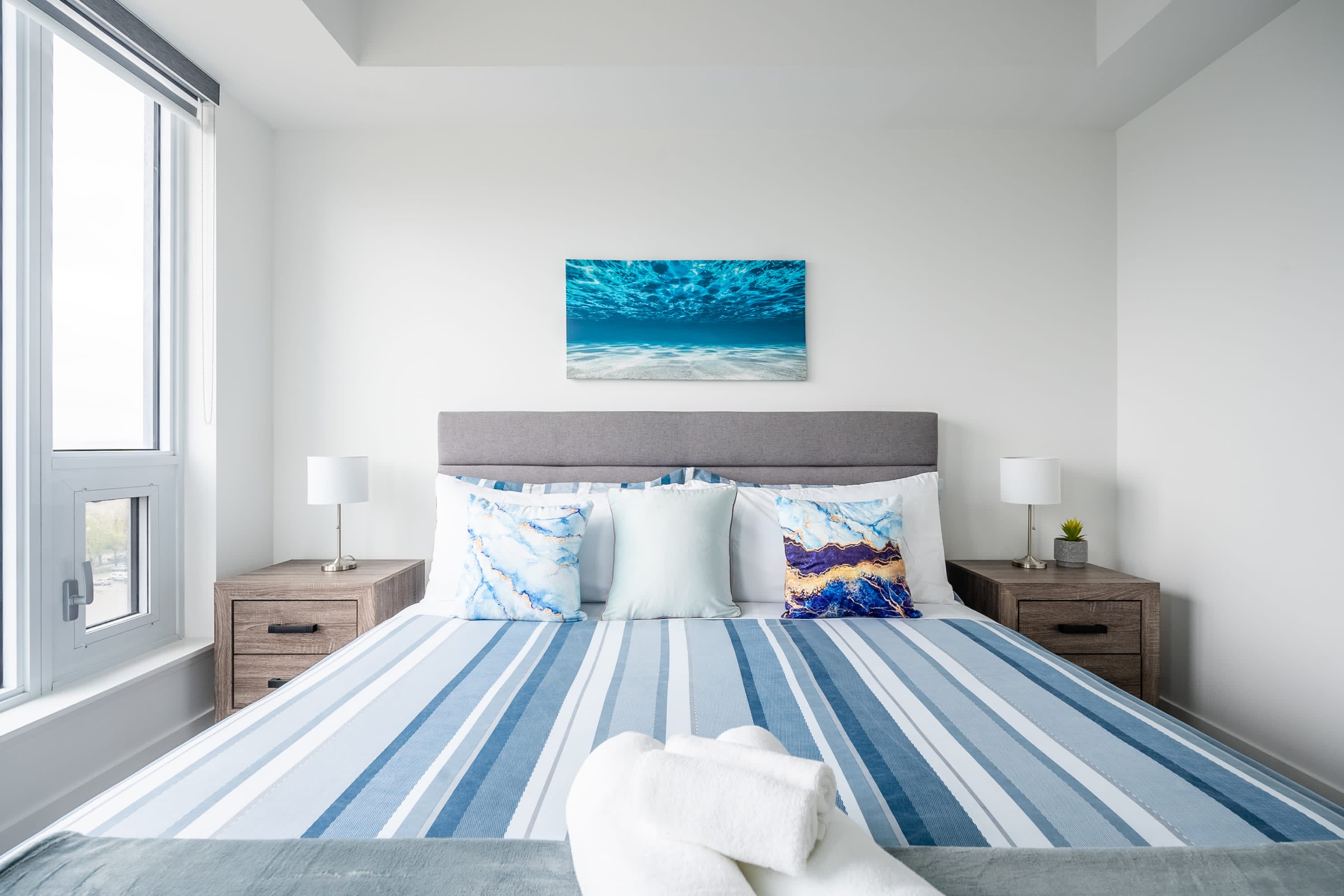 King Size Bed In A Bright And Airy Bedroom With Large Windows