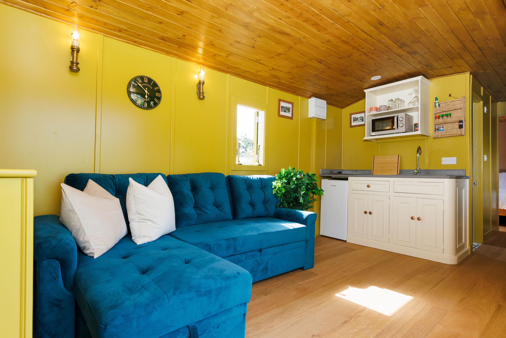 The surprisingly spacious living space has a comfortable sofa (transforms to bed for children) and well equipped kitchenette.