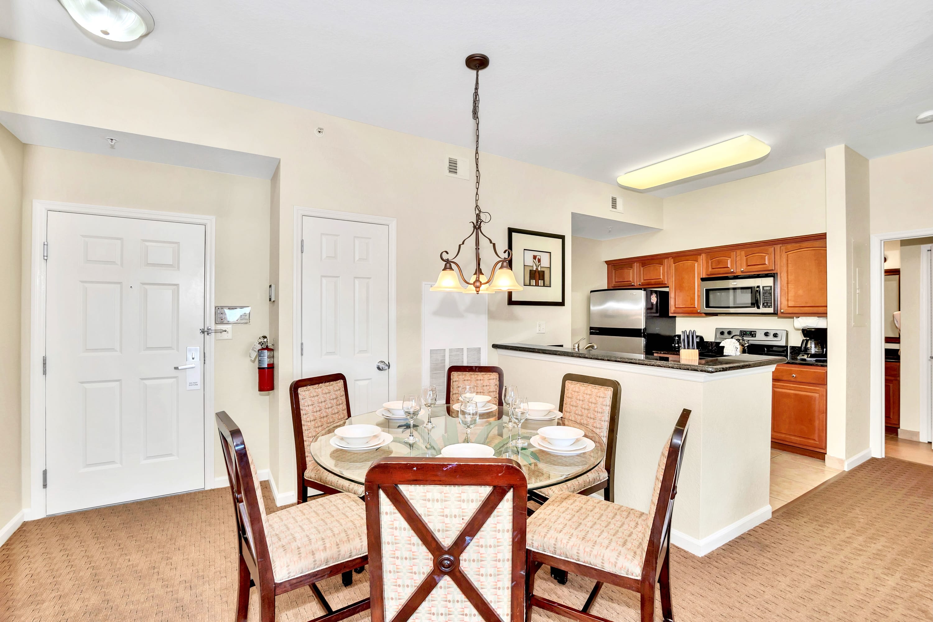 Open Dining Space With Glass-Topped Table And Seating For Six