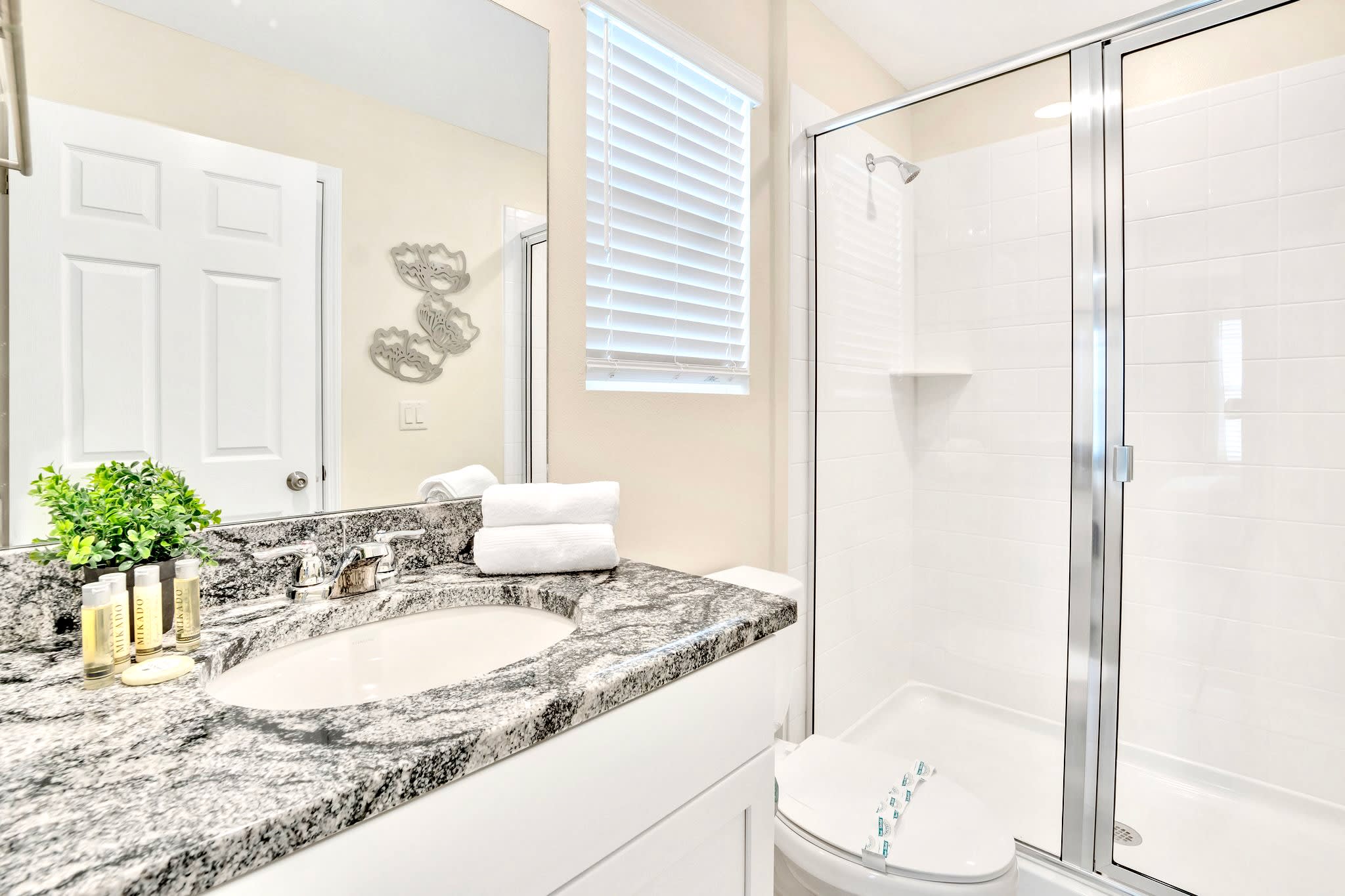 Clean And Stylish Bathroom With Walk-In Shower And Ample Lighting