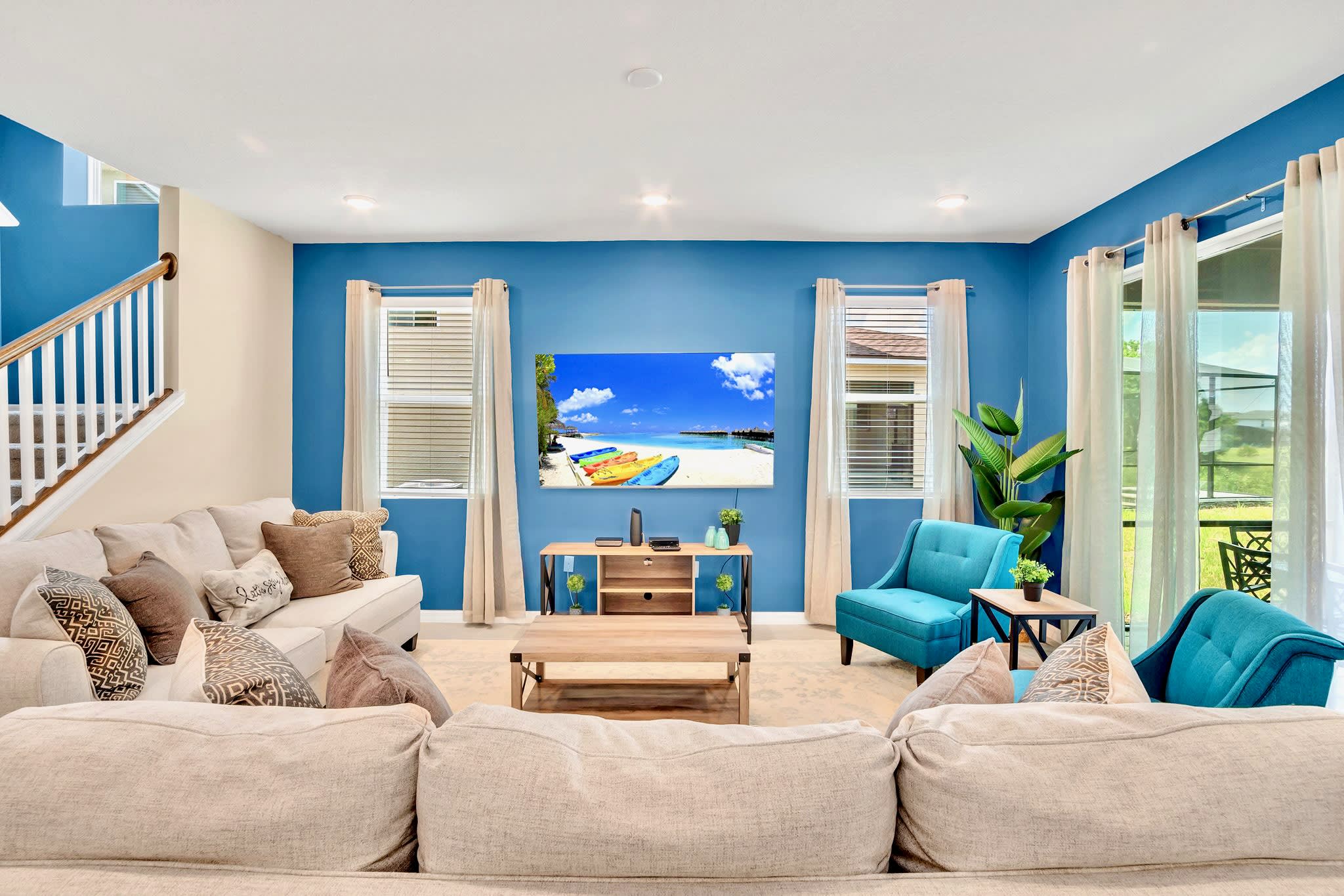 Comfortable Living Space Highlighting Blue Accents And Ample Seating