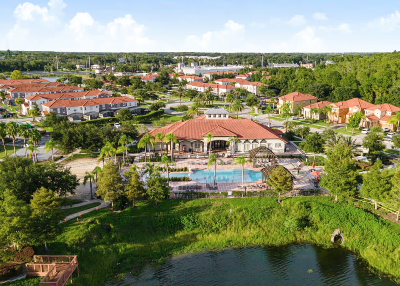 Stunning Aerial View Showcasing The Pool, Lake, And Resort Grounds