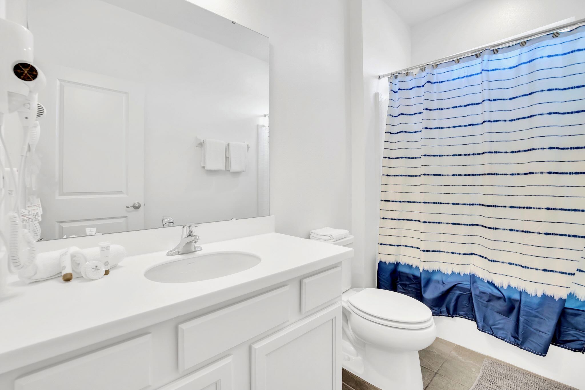 Bathroom With Double Vanity And A Spacious Shower Area