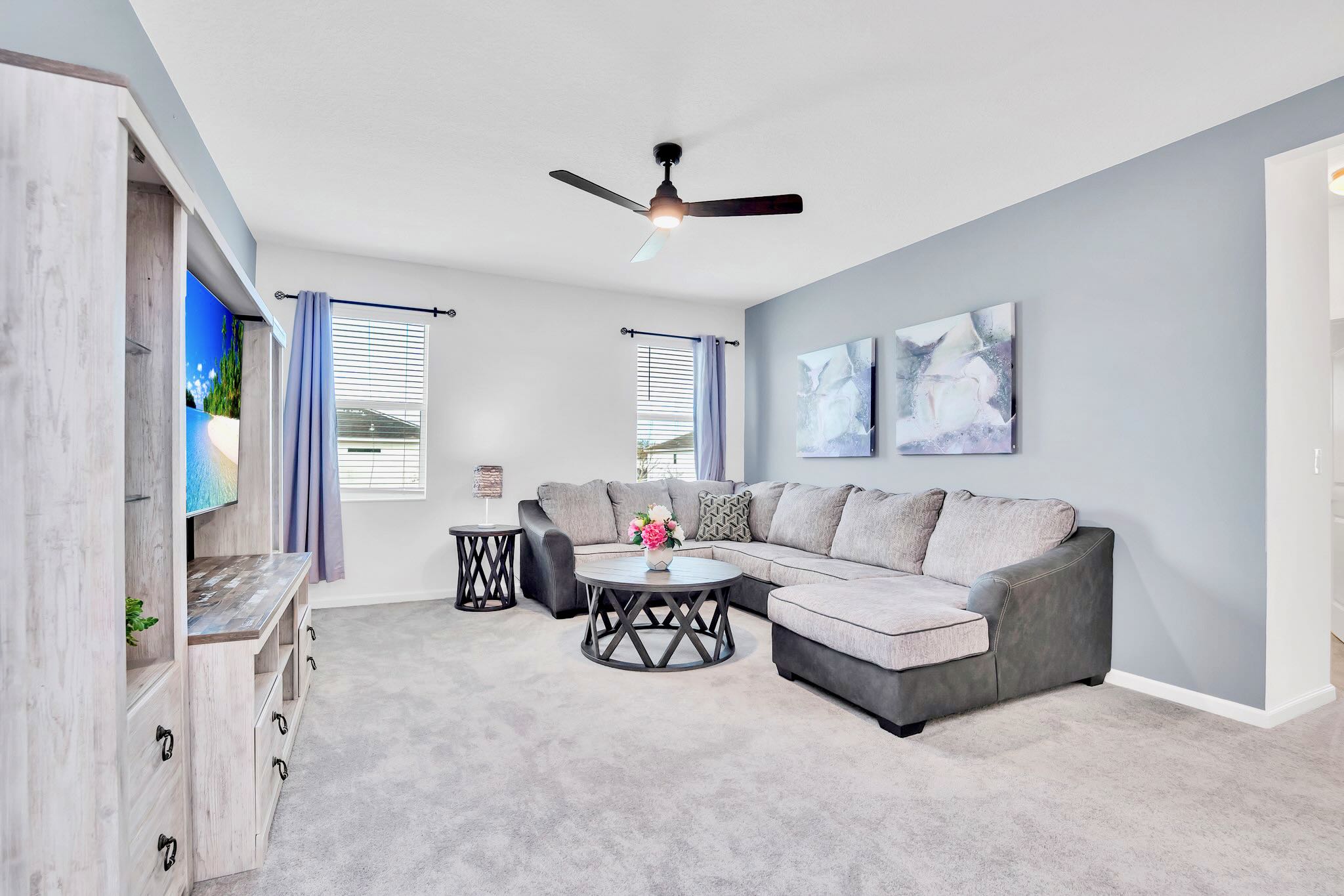 Open Concept Living Room With Plush Sectional And 65