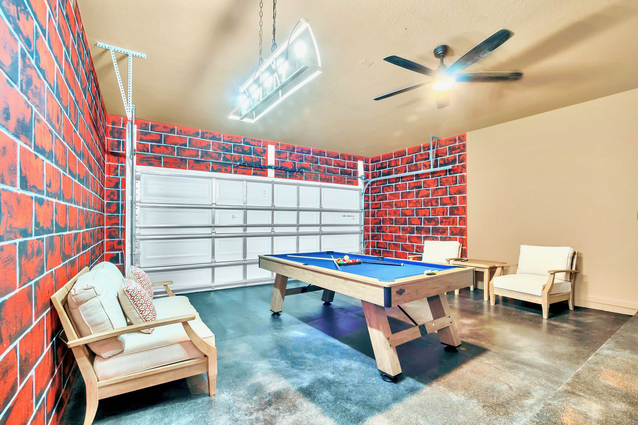 Garage Turned Billiards Room With Stylish Brick Wall Accents