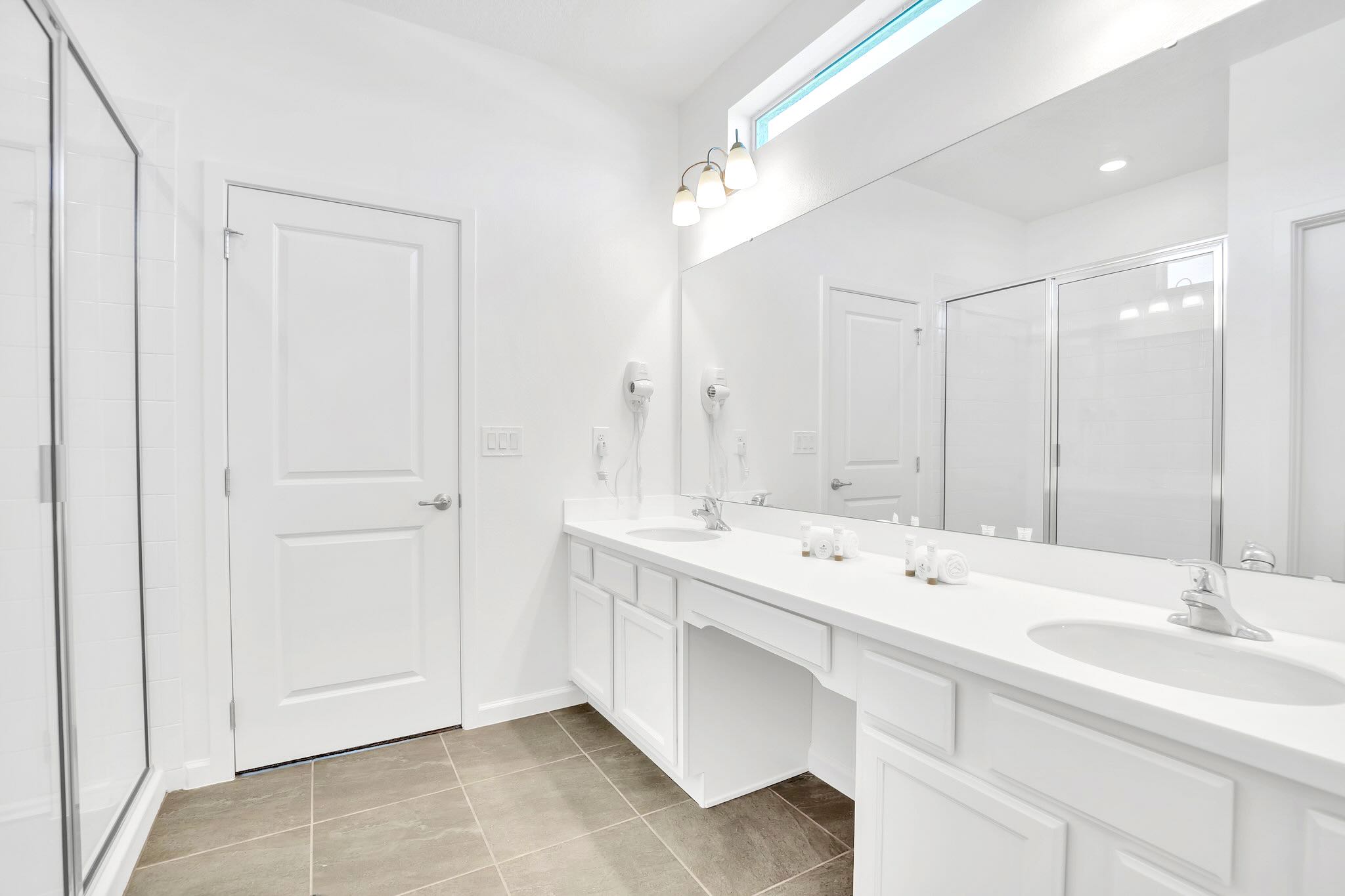 Spacious Bathroom With Decorative Blue And White Tiled Shower
