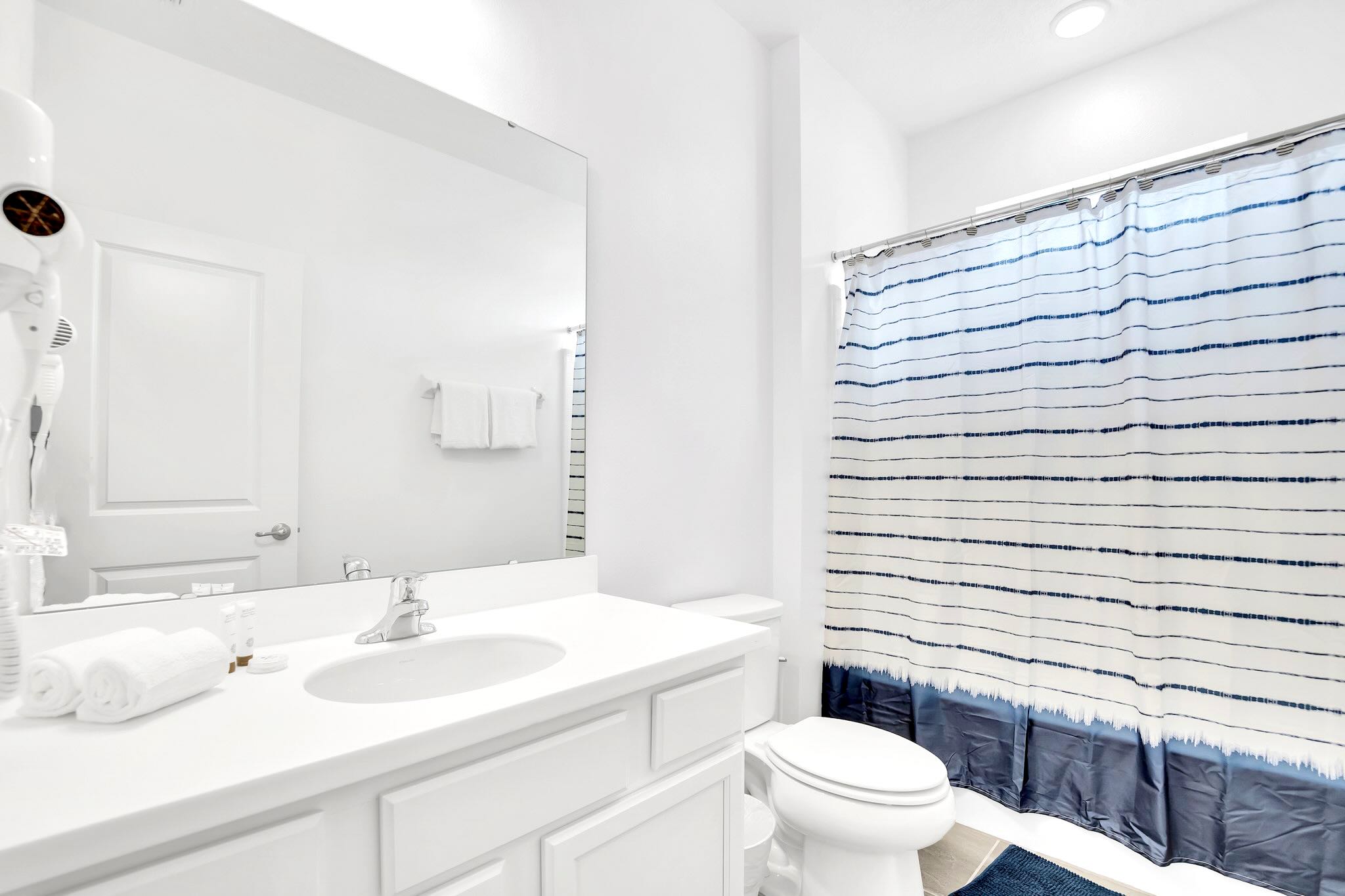 Bathroom With Double Vanity And A Spacious Shower Area