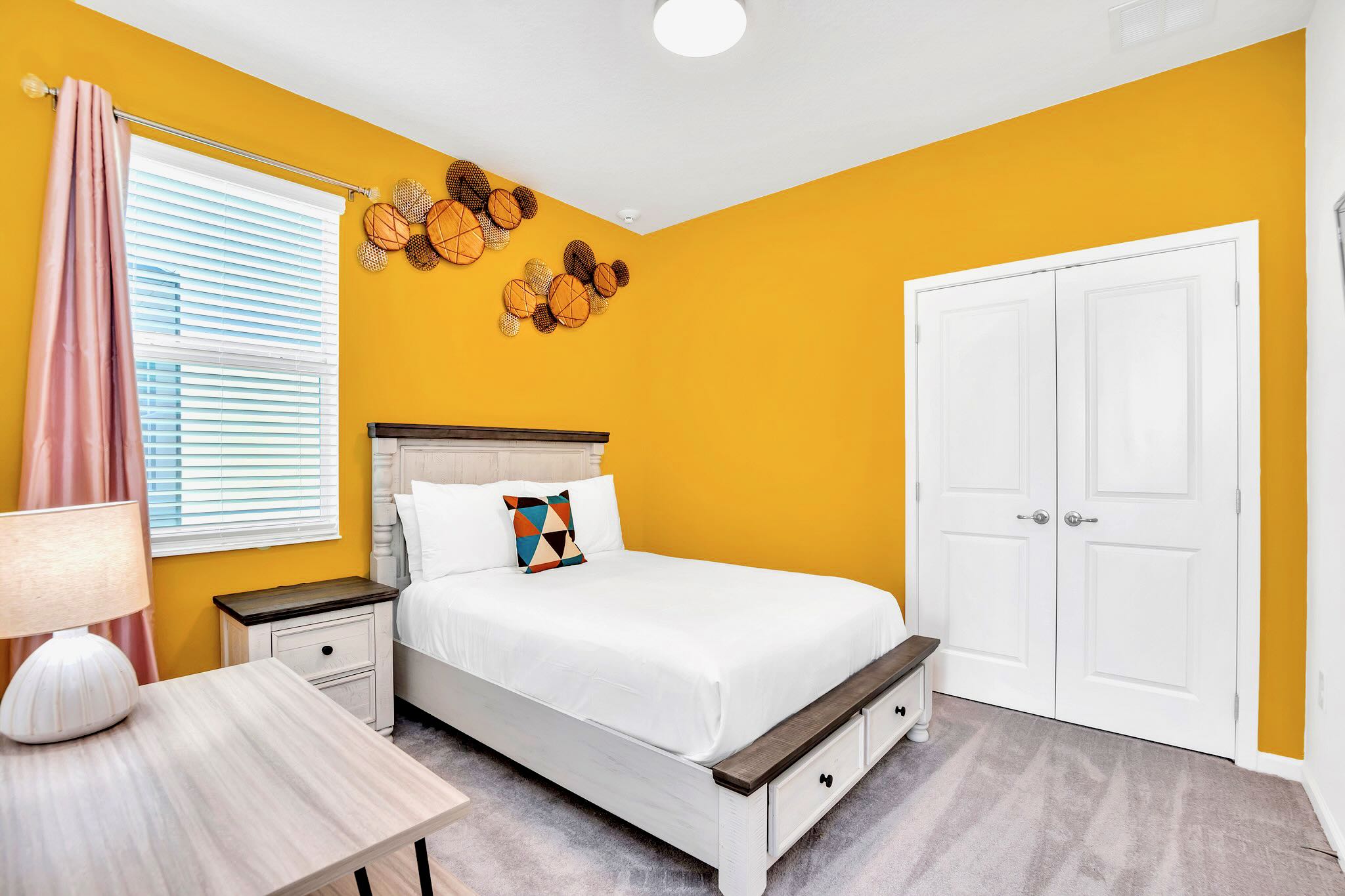 Full Bedroom With Warm Yellow Accents And Natural Light