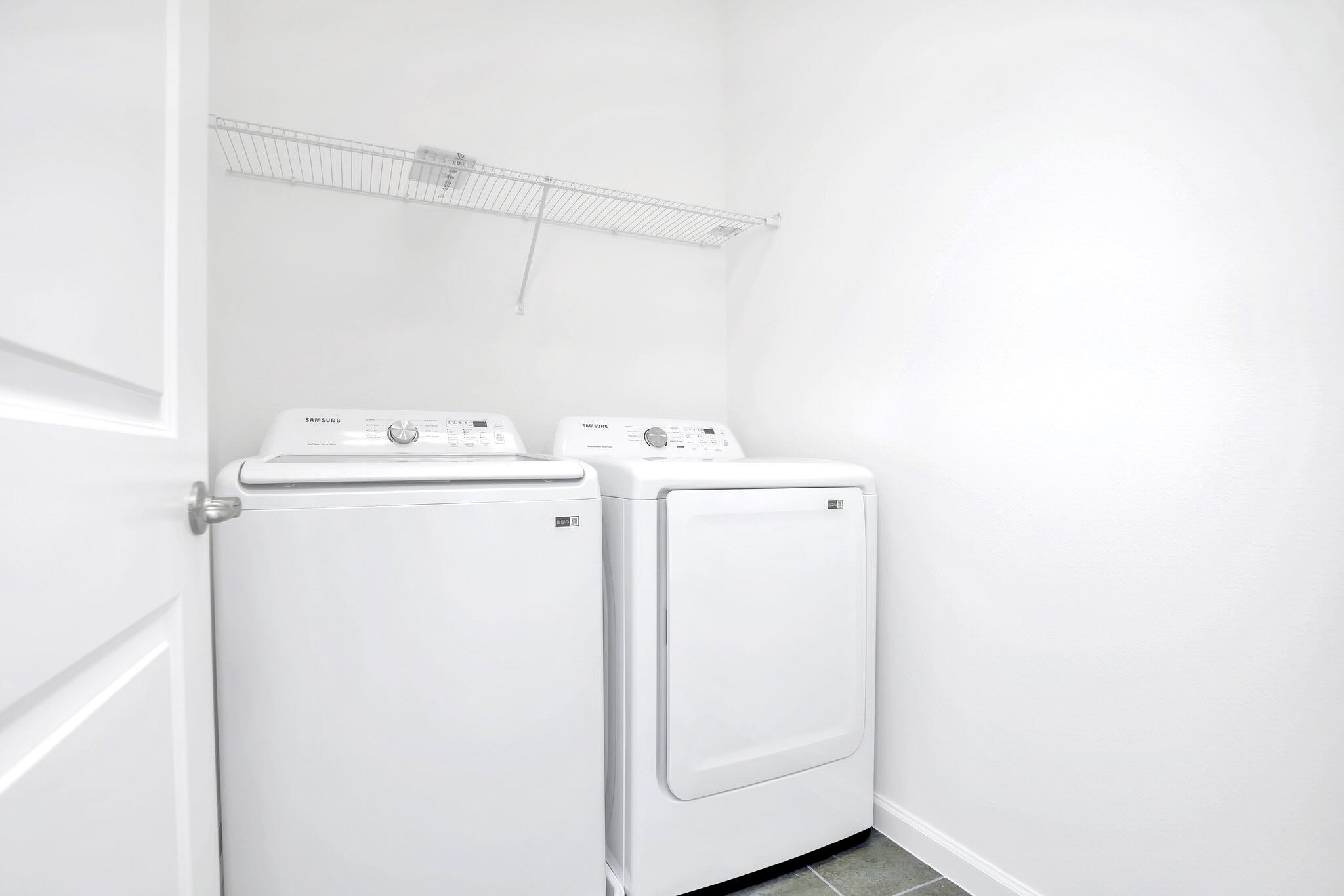 Laundry Area With Modern Washer And Dryer Units