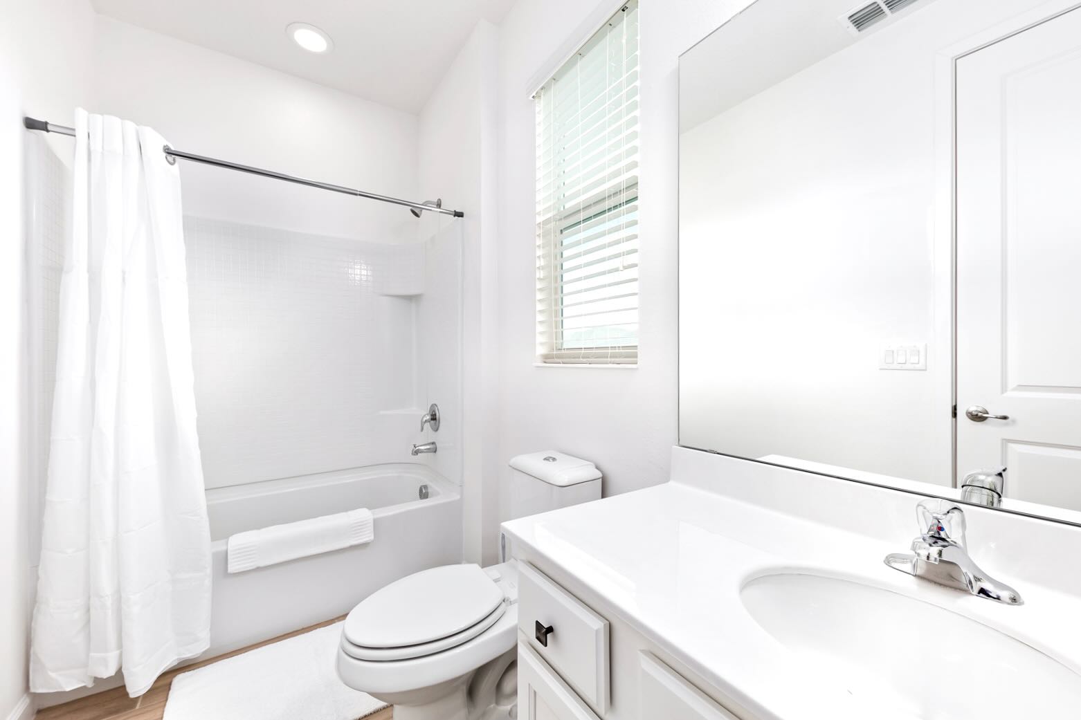 Bright Bathroom Featuring Clean Lines And A Shower Tub Combo