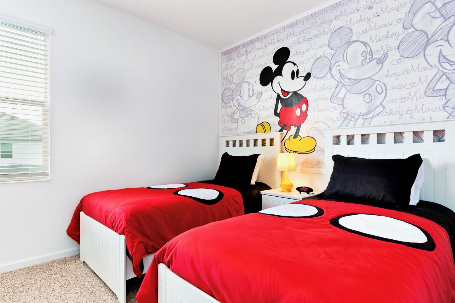 Mickey Mouse Themed Twin Bedroom With Vibrant Red Bedding And Fun Decor