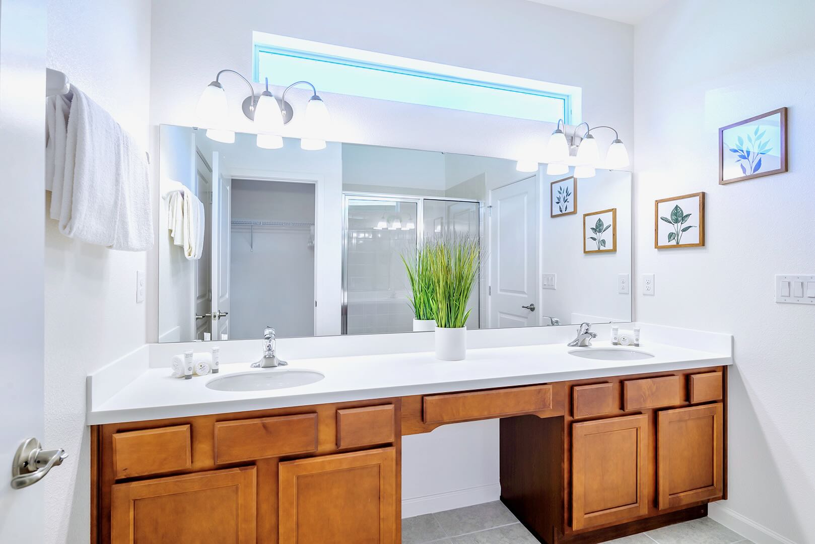 Bright And Spacious Bathroom Featuring A Double Vanity And Elegant Décor