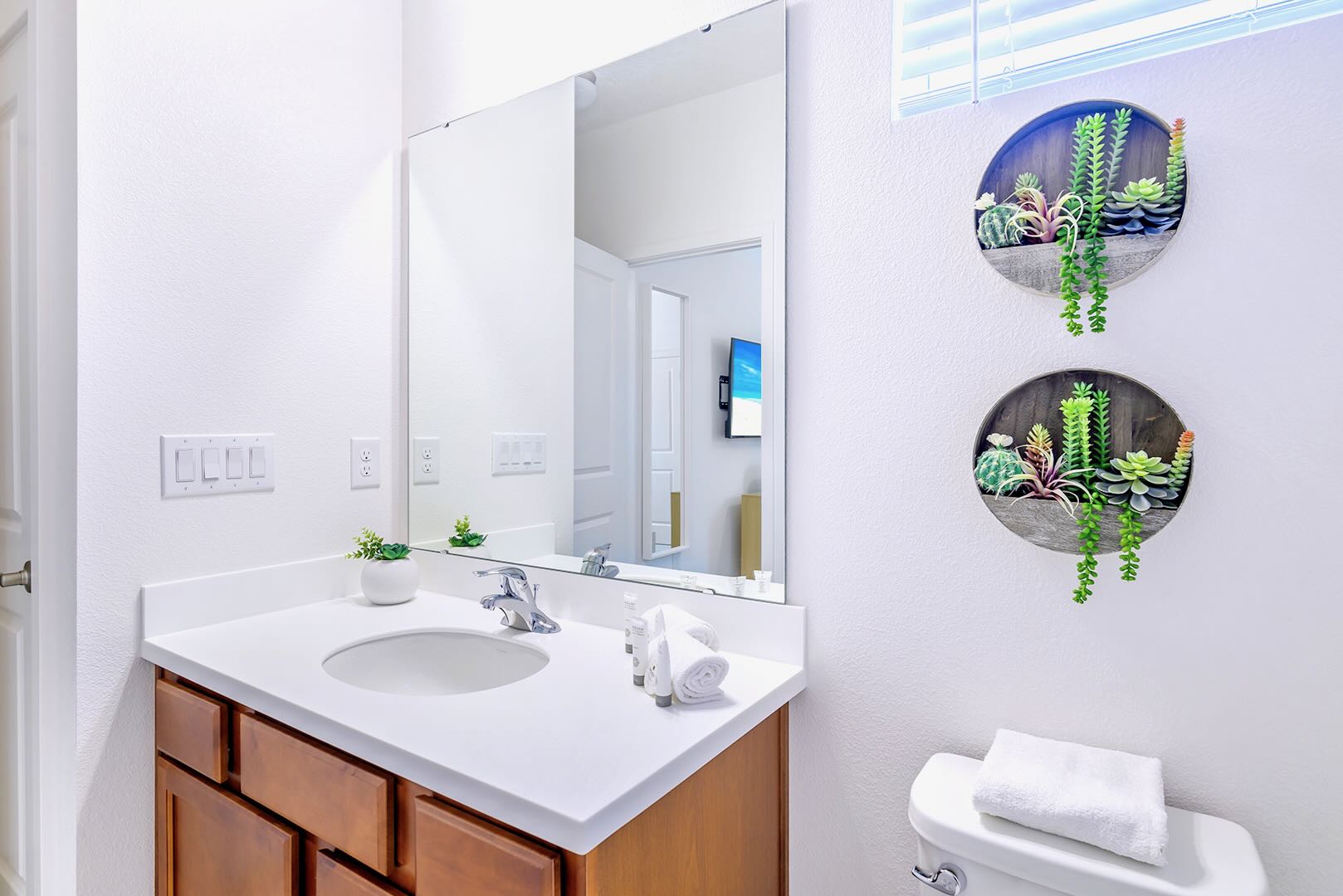Bright And Spacious Bathroom Featuring A Double Vanity And Elegant Décor