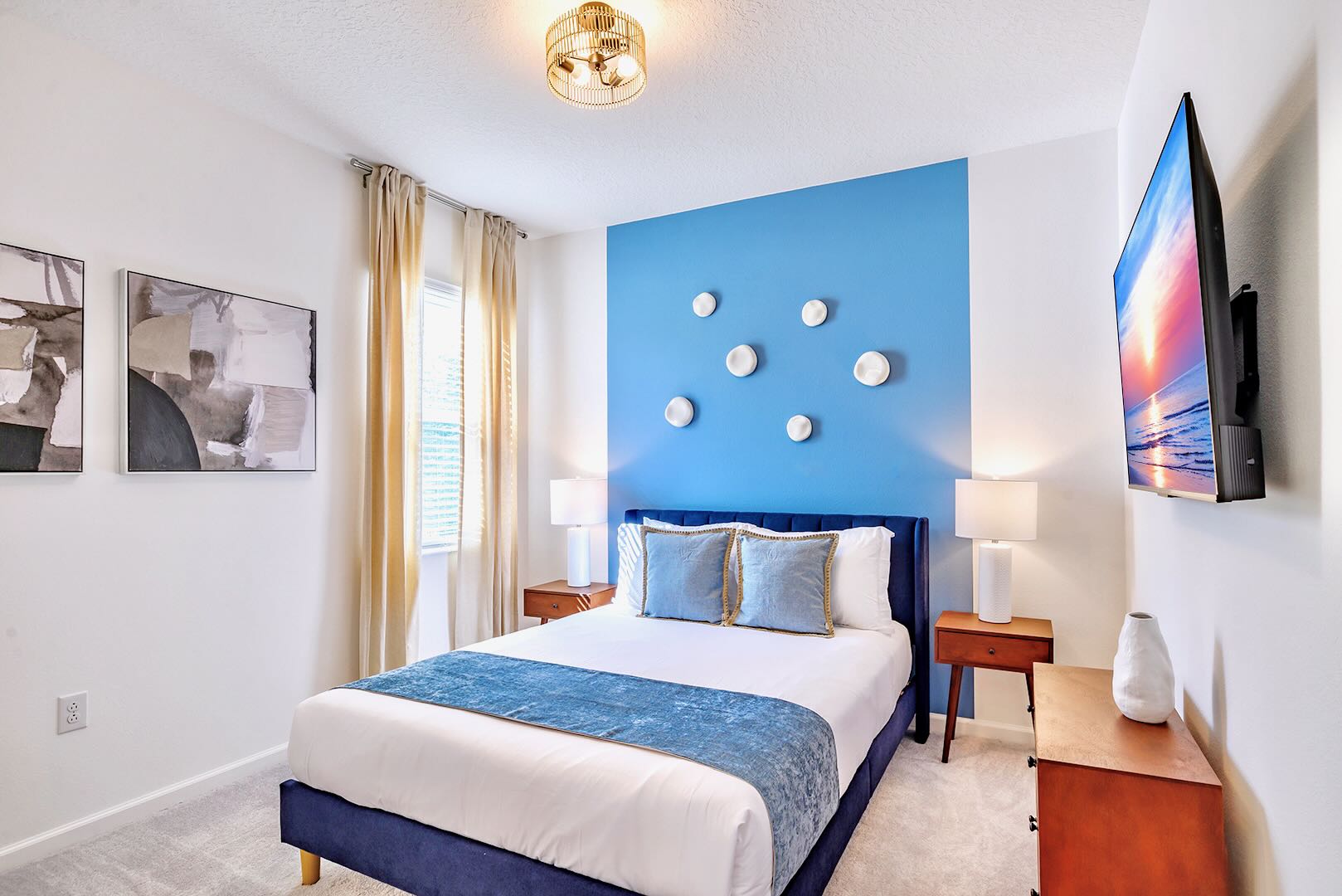 Stylish Room Featuring A Queen Bed, Bold Wall Art, And Sleek Furnishings