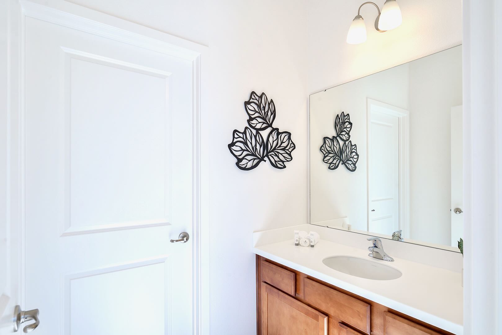 Bright And Spacious Bathroom Featuring A Double Vanity And Elegant Décor