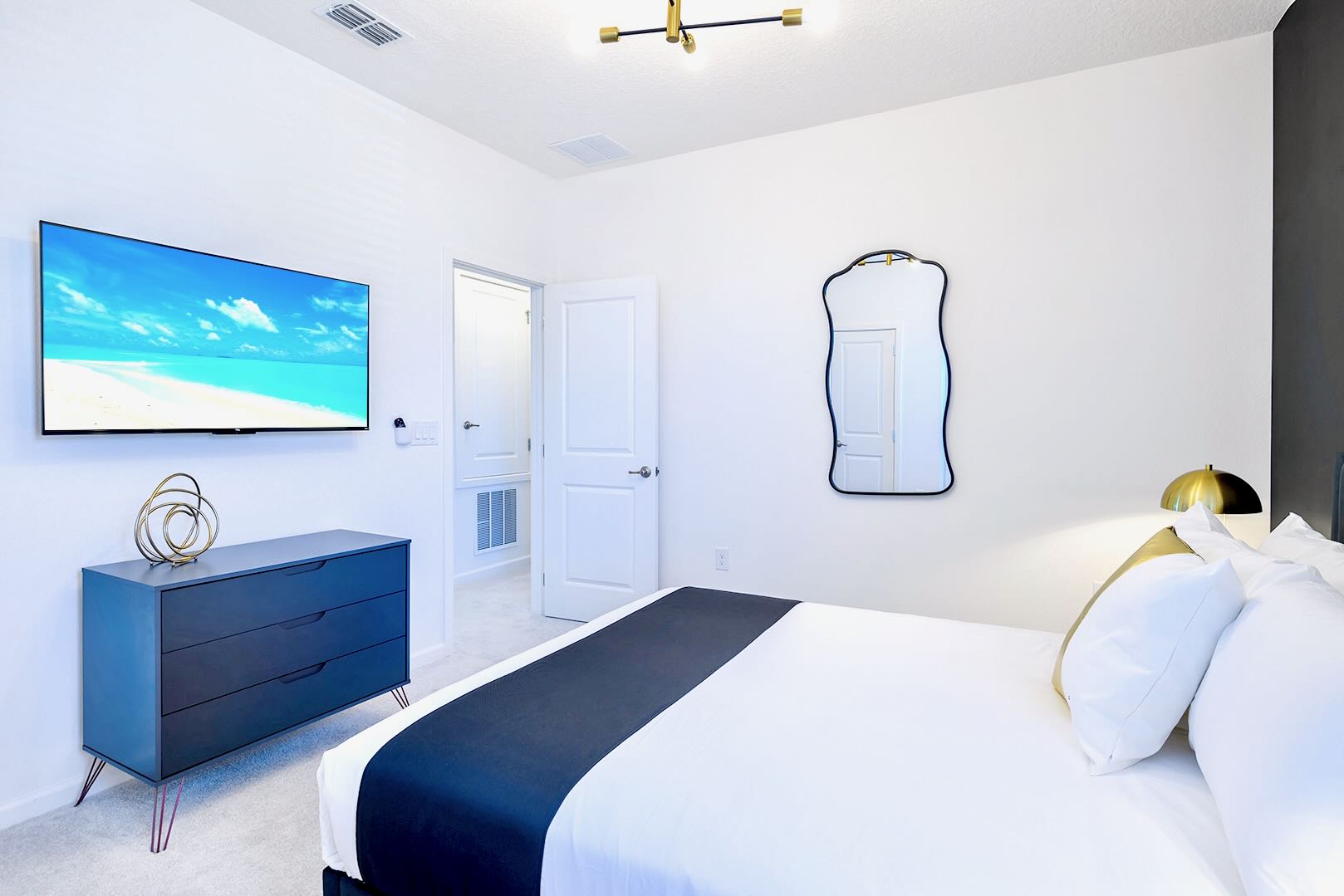 Stylish Room Featuring A King Bed, Bold Wall Art, And Sleek Furnishings