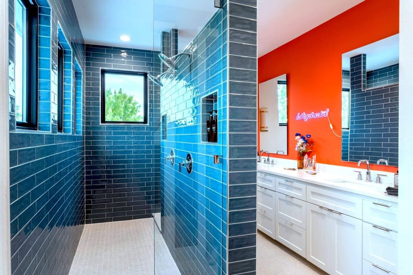 Spacious shower with double sinks and natural light