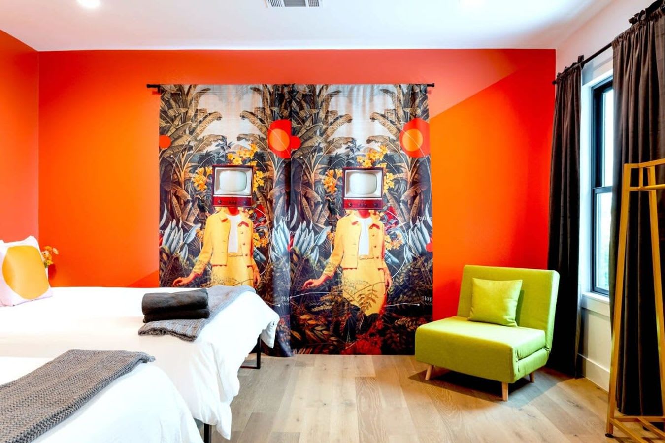 Two queen beds with natural light and single sofa bed.