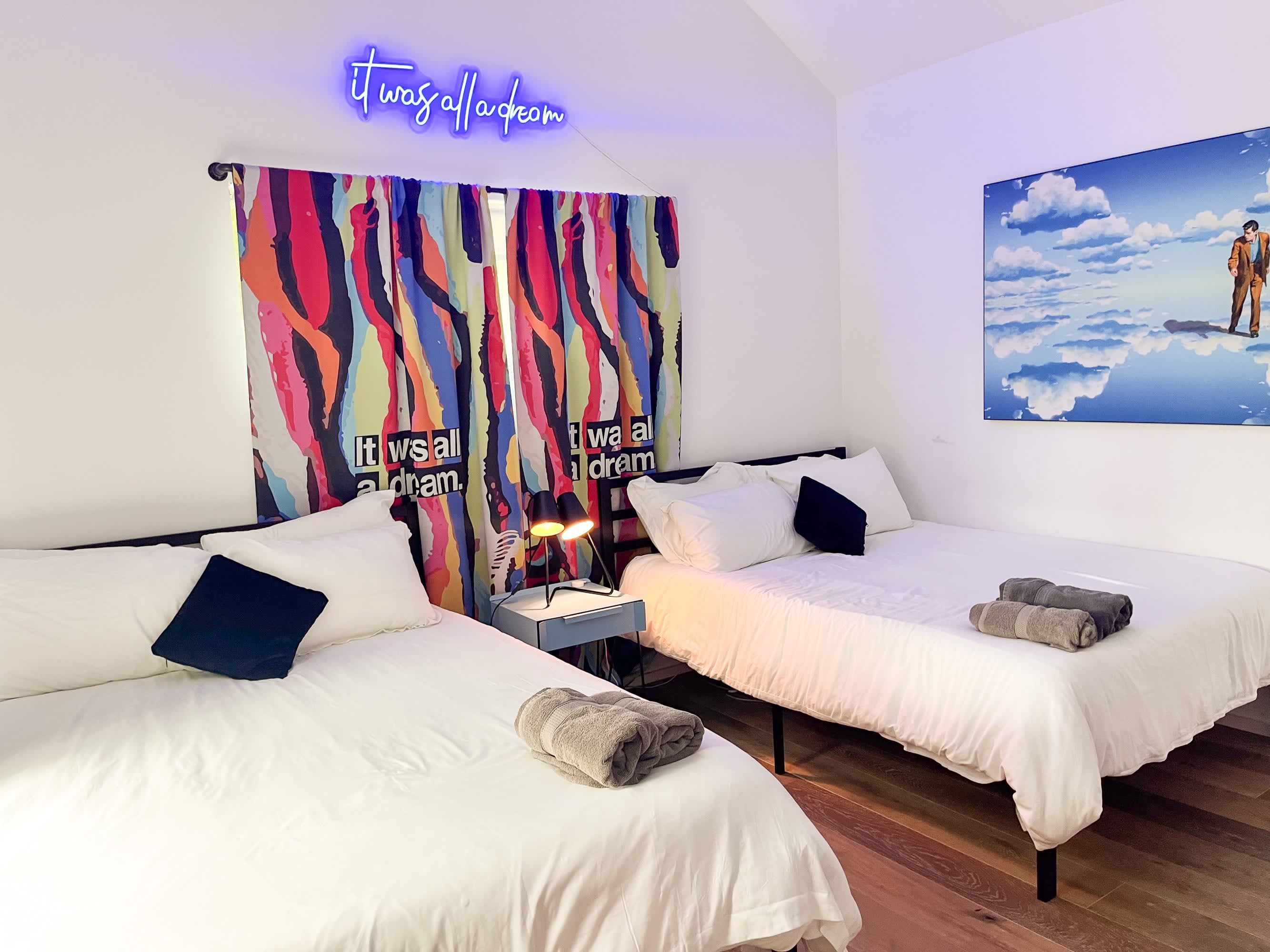 Stylish Bedroom With Two Queen Beds, Colorful Decor, And Eye-Catching Details