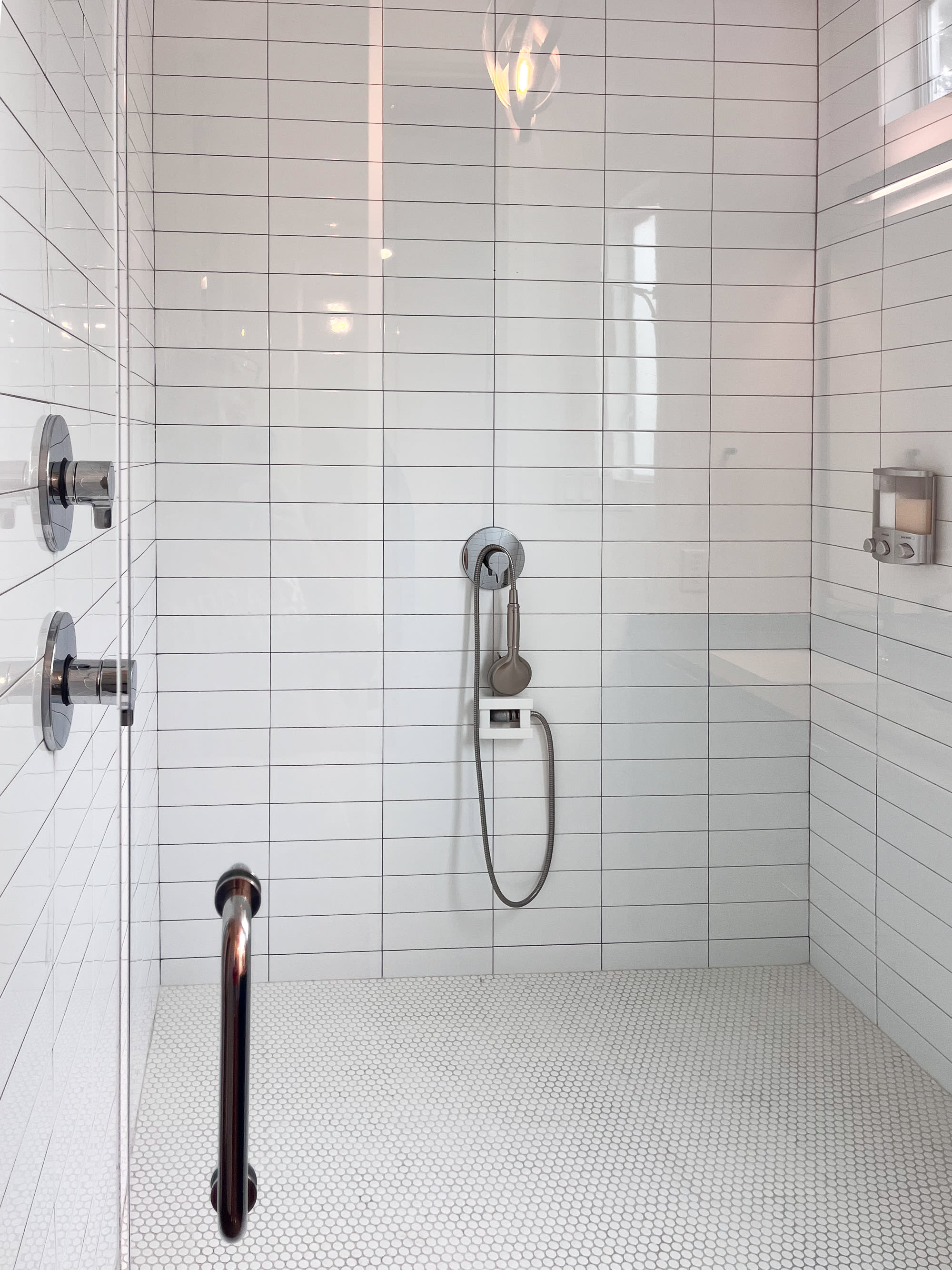 Sleek Walk-In Shower With Modern Fixtures And Subway Tile Design