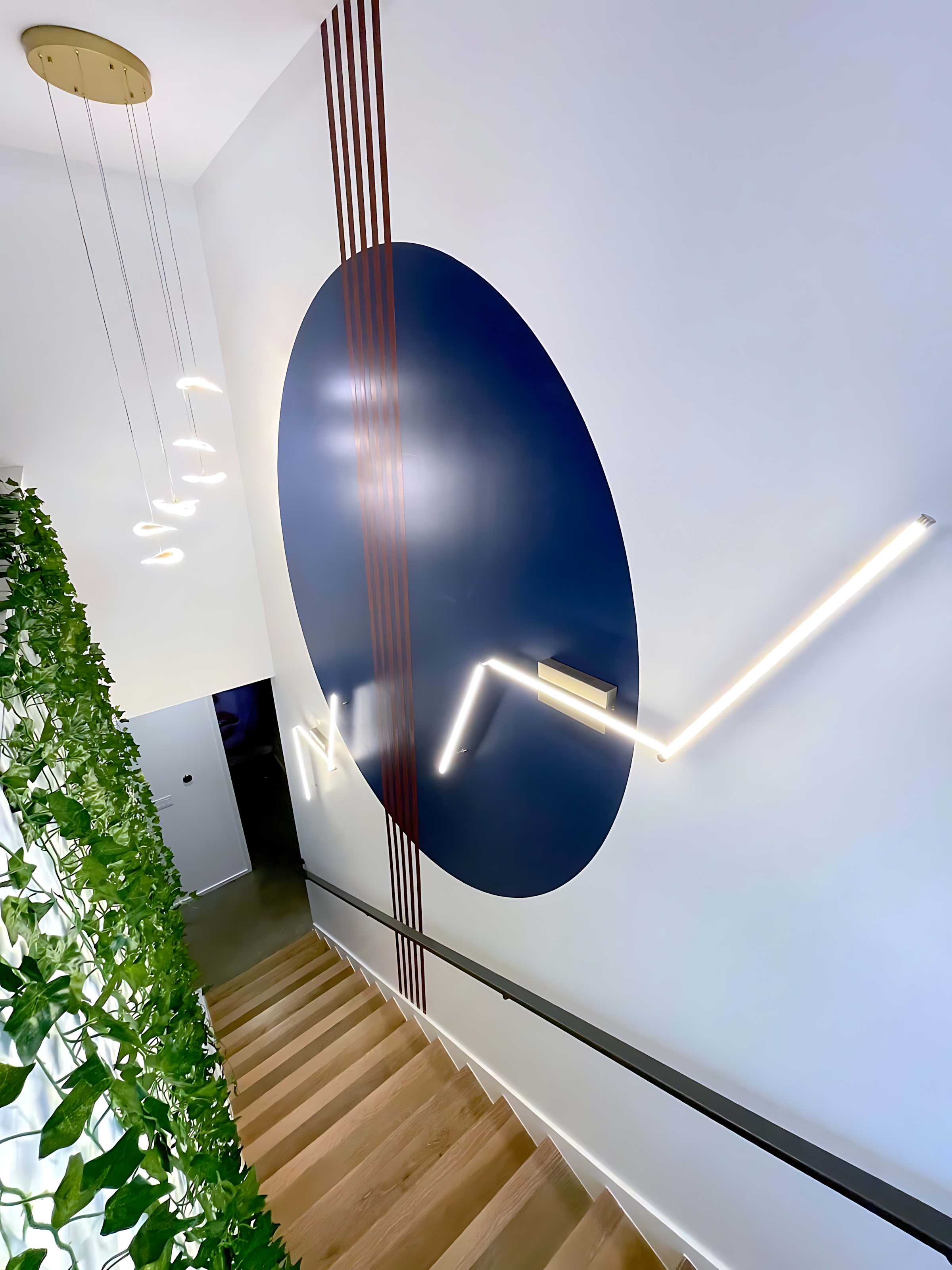 Sleek Staircase With Artistic Lighting And Modern Wall Accents