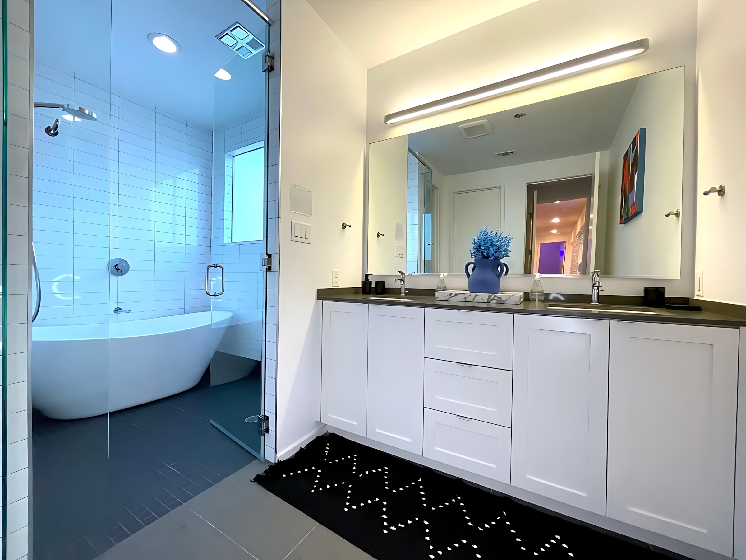 Bright Bathroom With A Freestanding Tub, Walk-In Shower, And Double Vanity