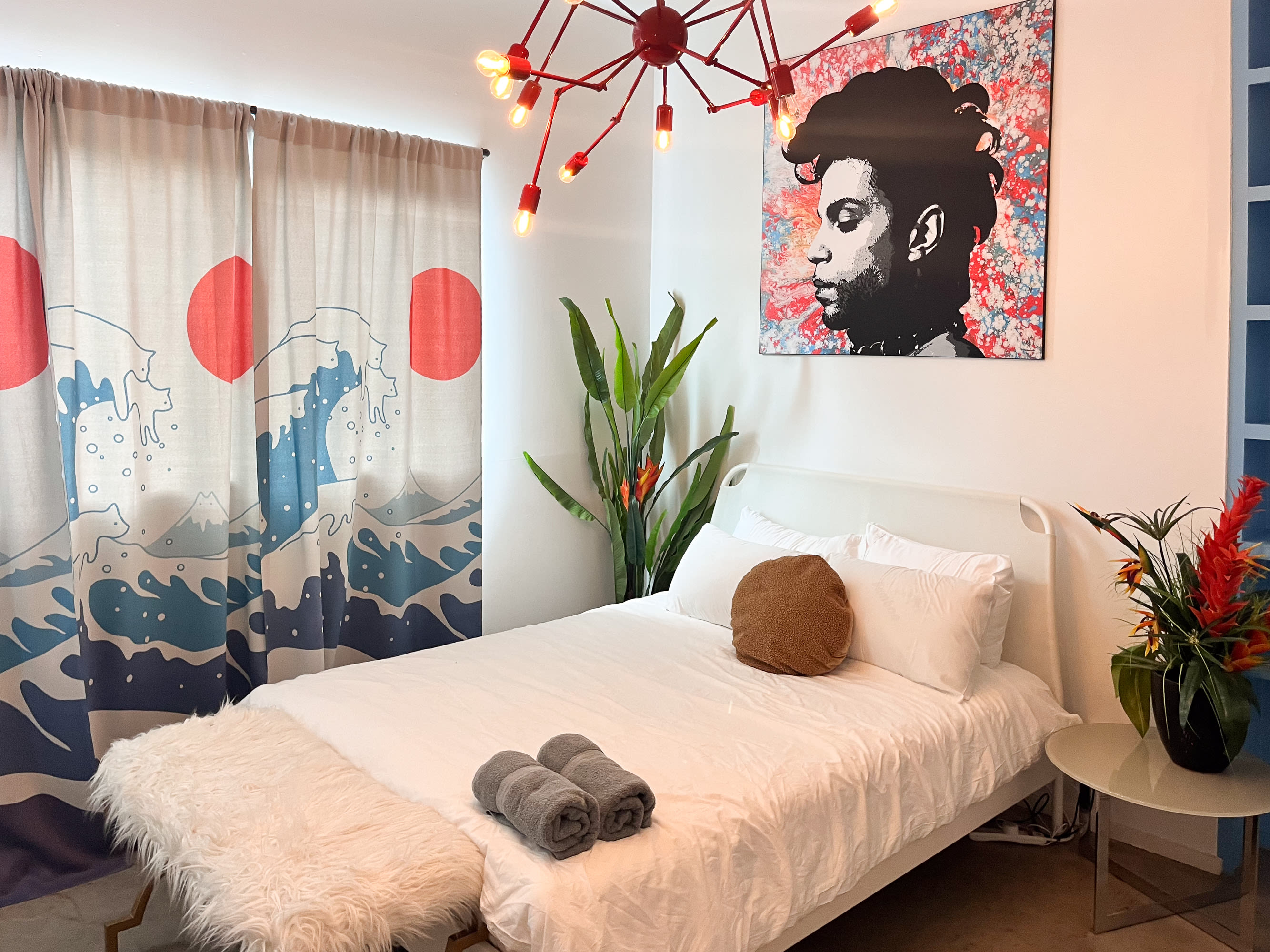 Artistic Bedroom With A Queen Bed, Vibrant Curtains, And Bold Wall Art