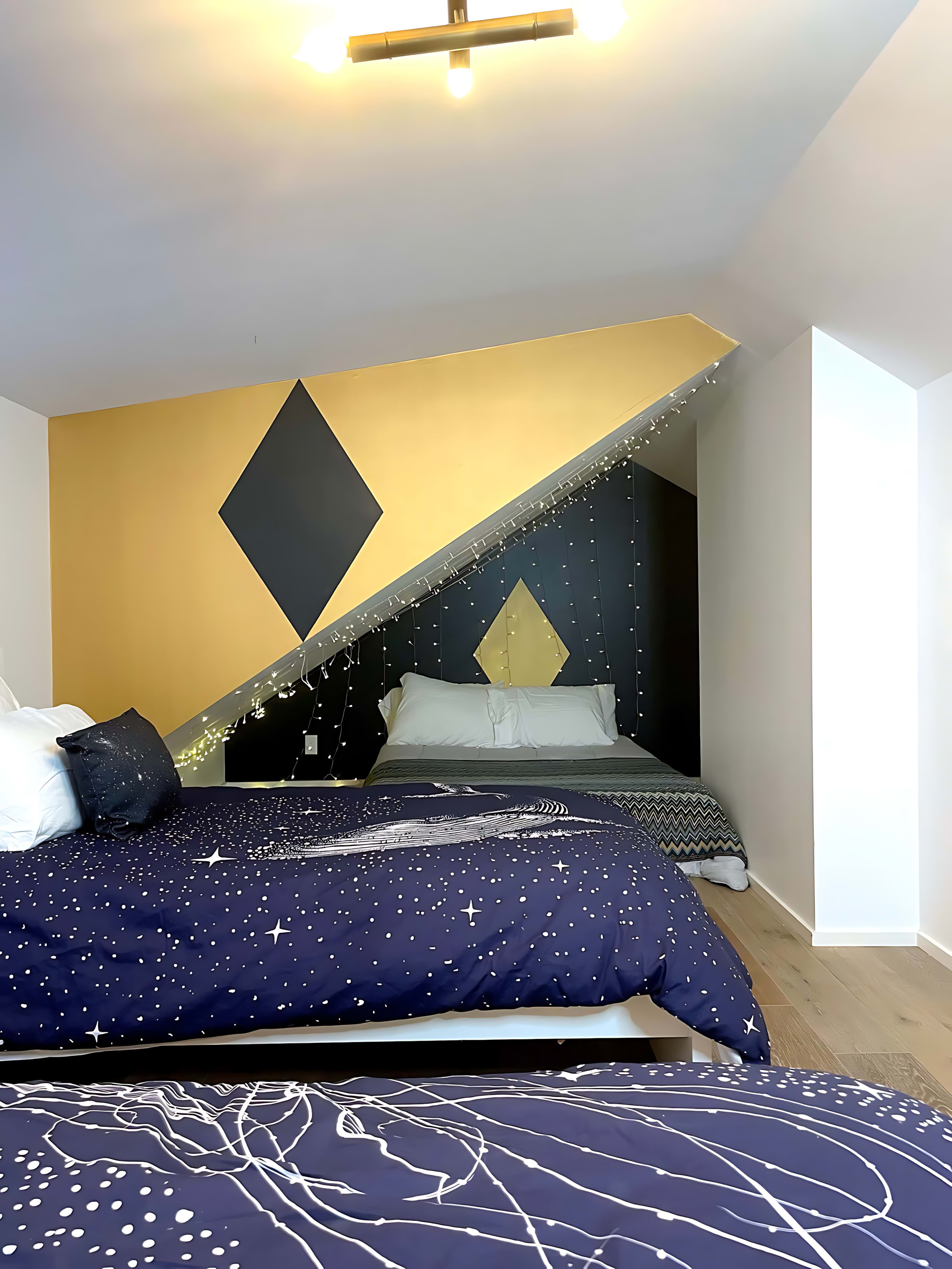 Cozy Nook With A Queen Bed, Fairy Lights, And Artistic Wall Accents