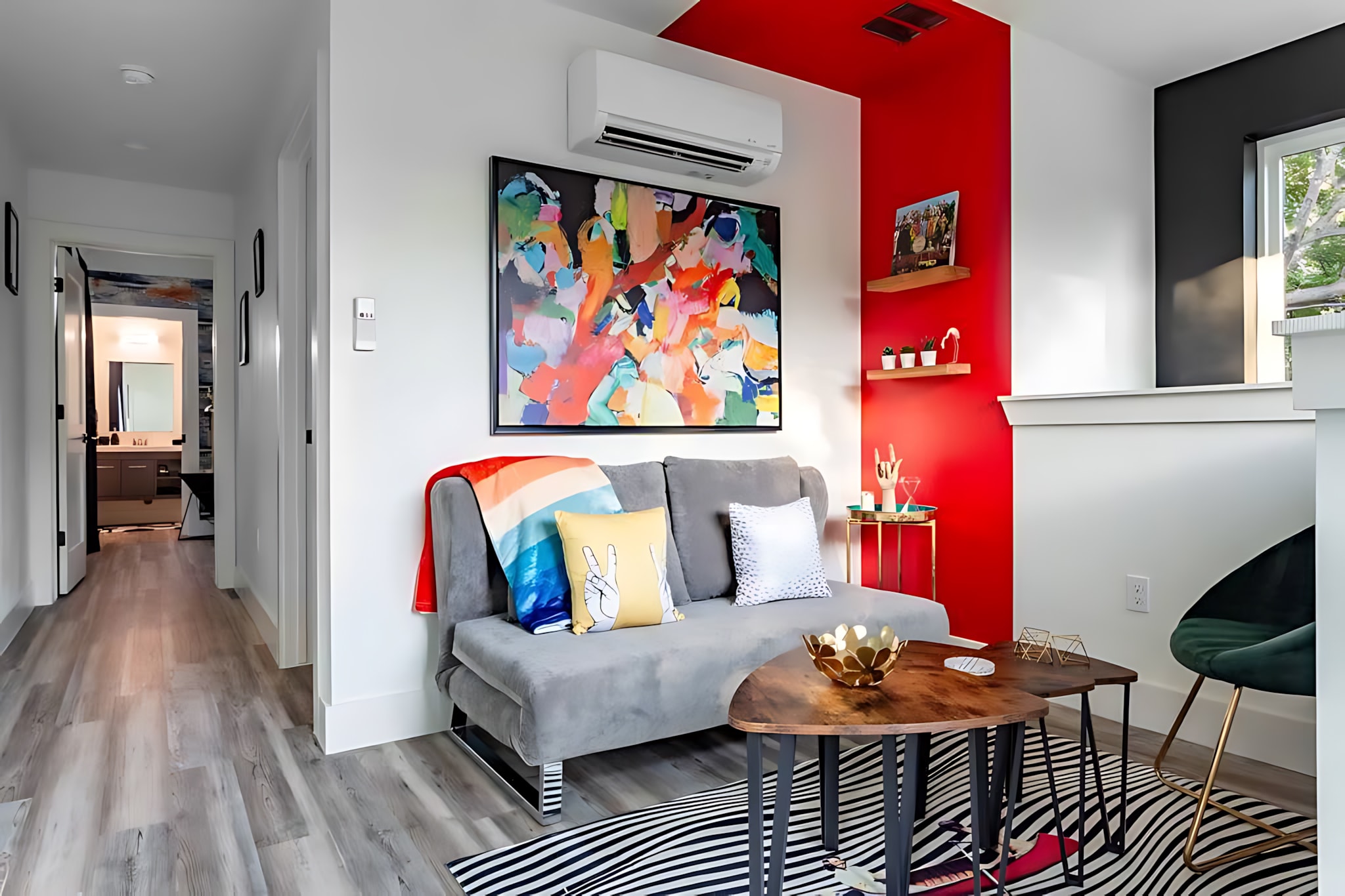 Cozy Living Space With Modern Art, Vibrant Color Accents, And A Comfortable Sofa Bed
