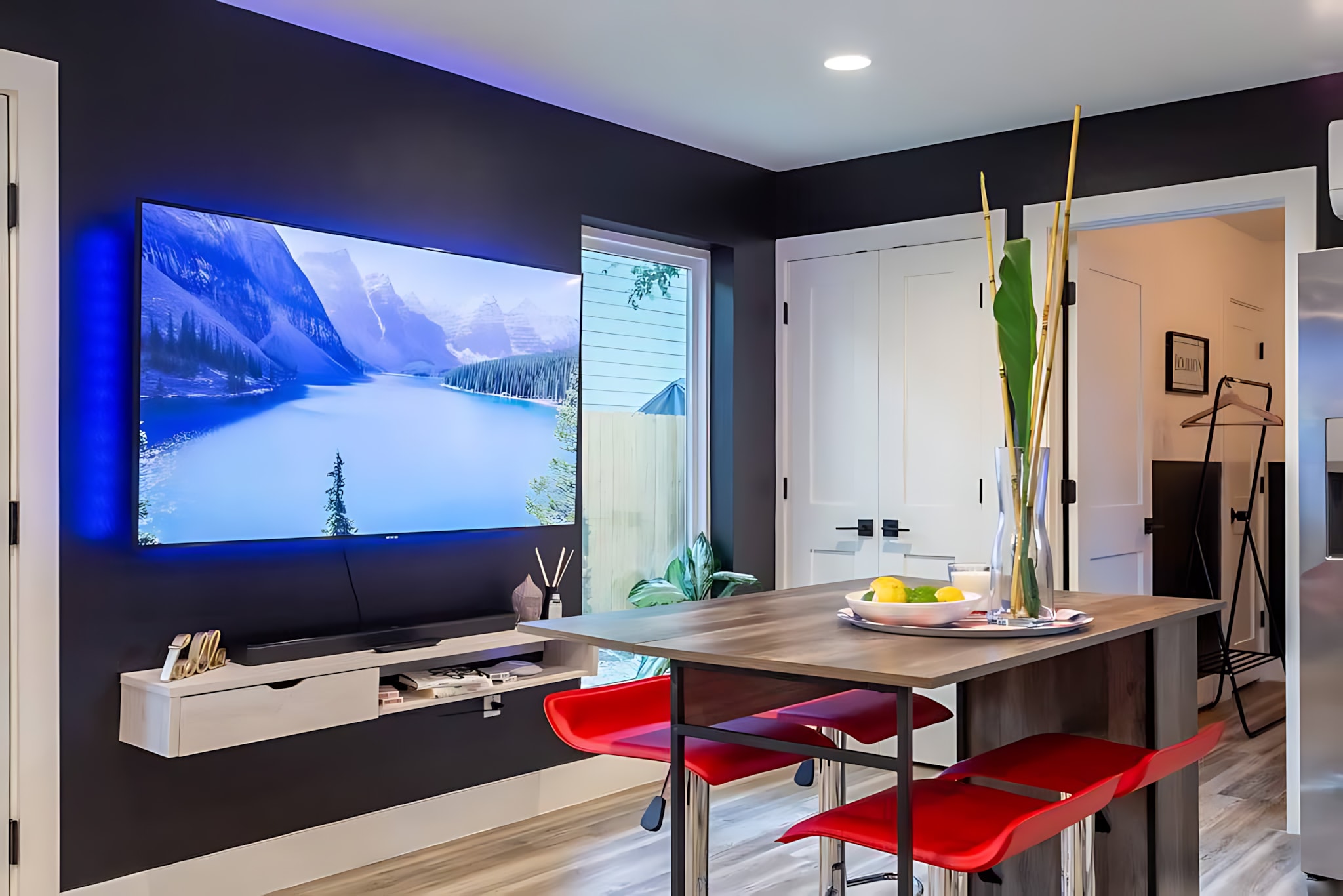 Smart TV Mounted On The Wall With Modern Kitchen Table