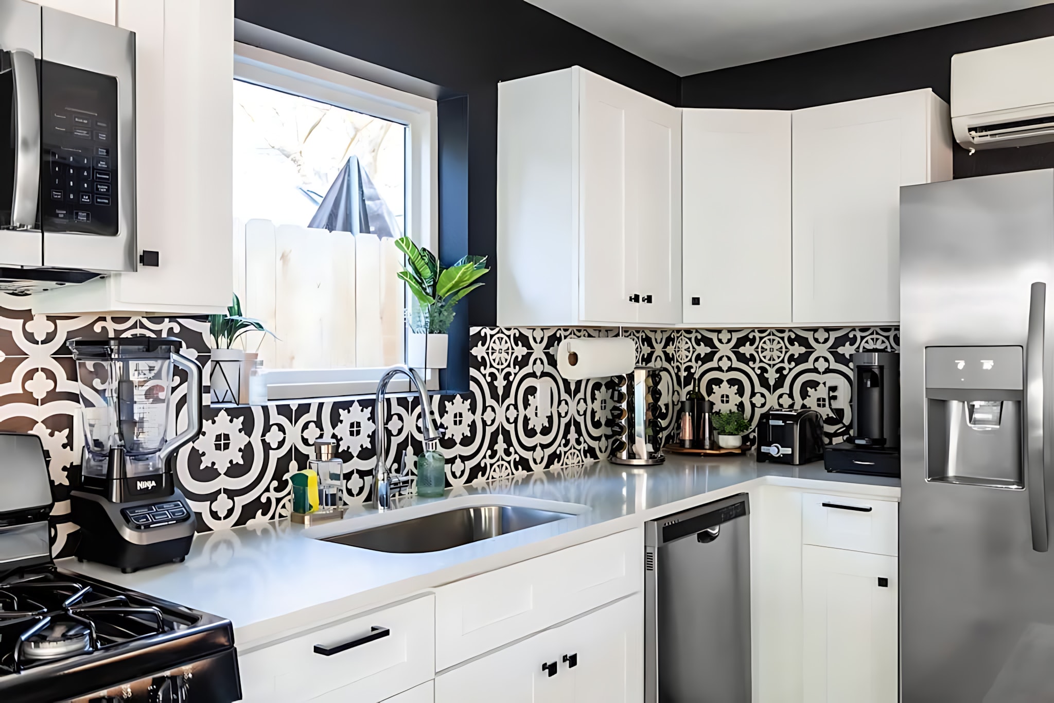 Fully Equipped Kitchen With Stylish Patterned Backsplash And Modern Appliances
