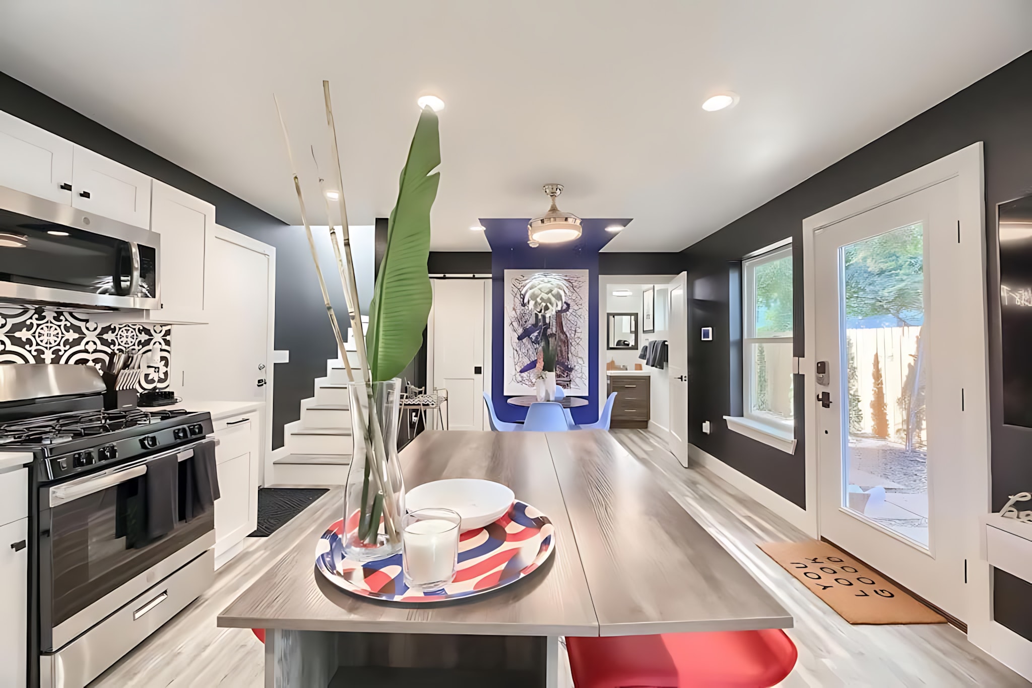 Spacious Kitchen And Dining Area With Modern Design And Vibrant Decor Details