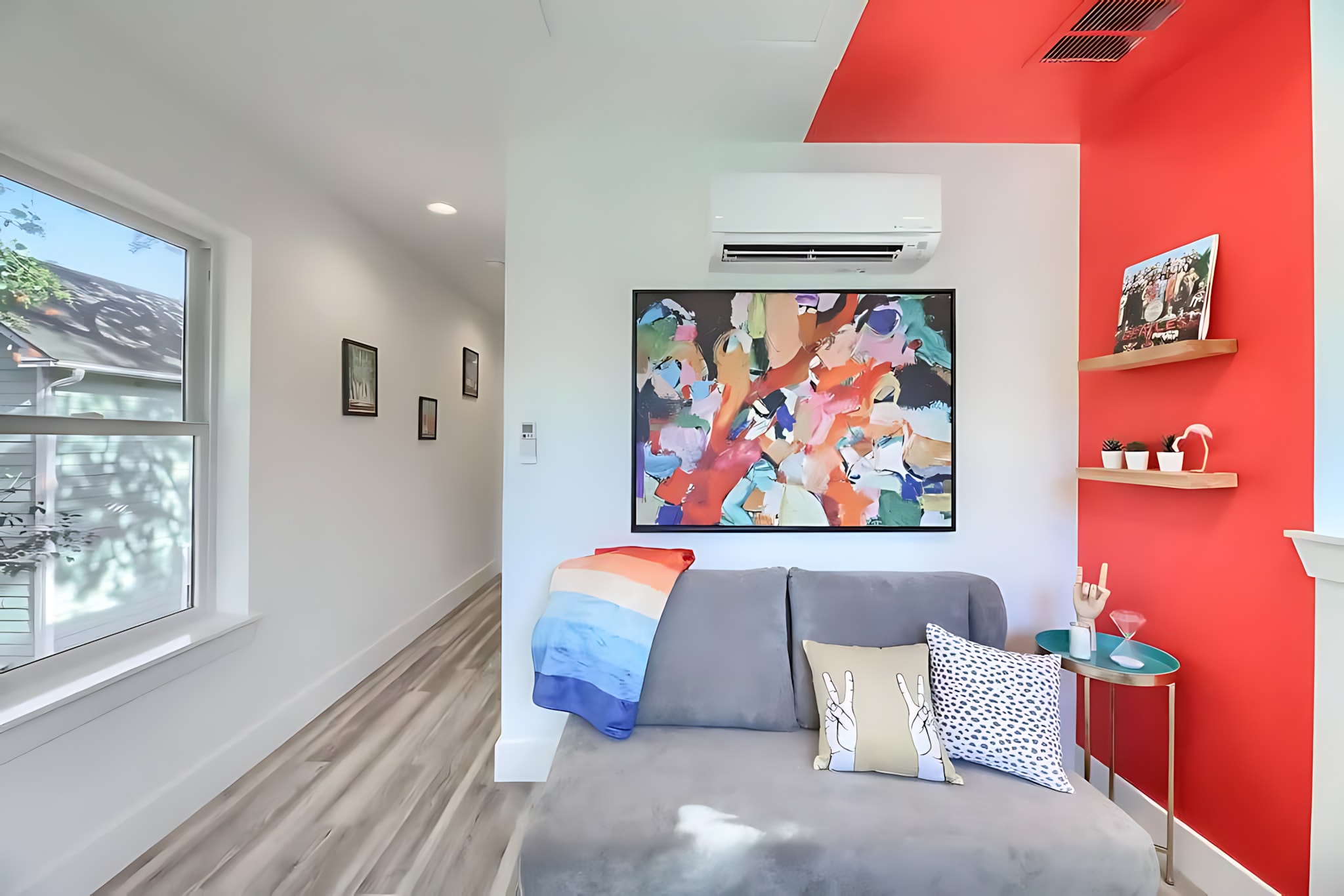 Cozy Living Space With Modern Art, Vibrant Color Accents, And A Comfortable Sofa Bed