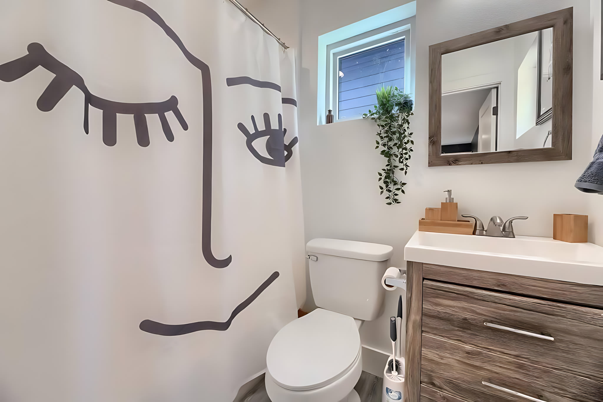 Cozy Bathroom With Playful Decor And Natural Light