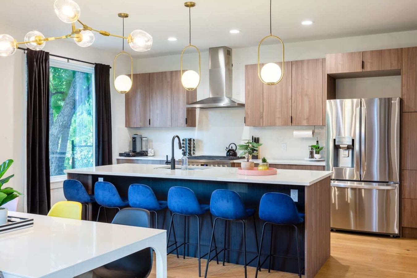 Modern Kitchen With A Spacious Island And Stylish High Chairs