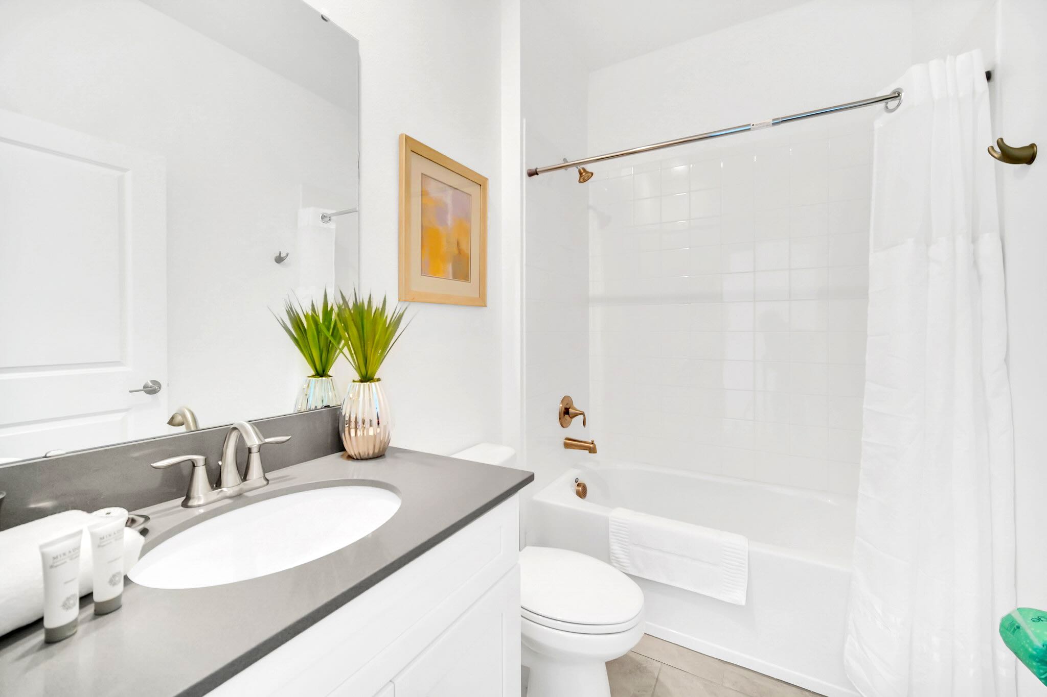 Spacious Bathroom Featuring Double Sinks And A Relaxing Tub