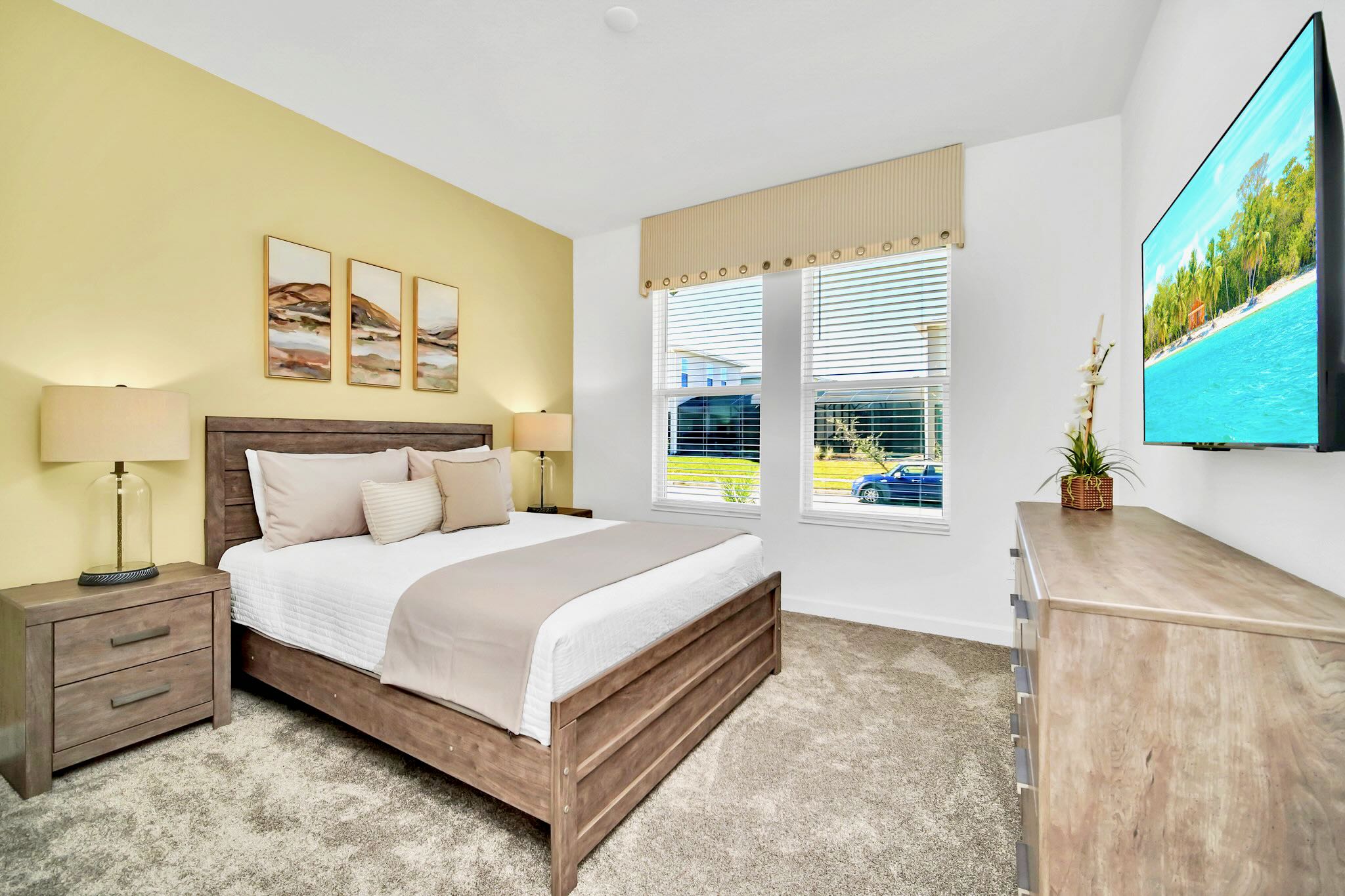 Rest Comfortably In This Spacious Bedroom With Yellow Decor