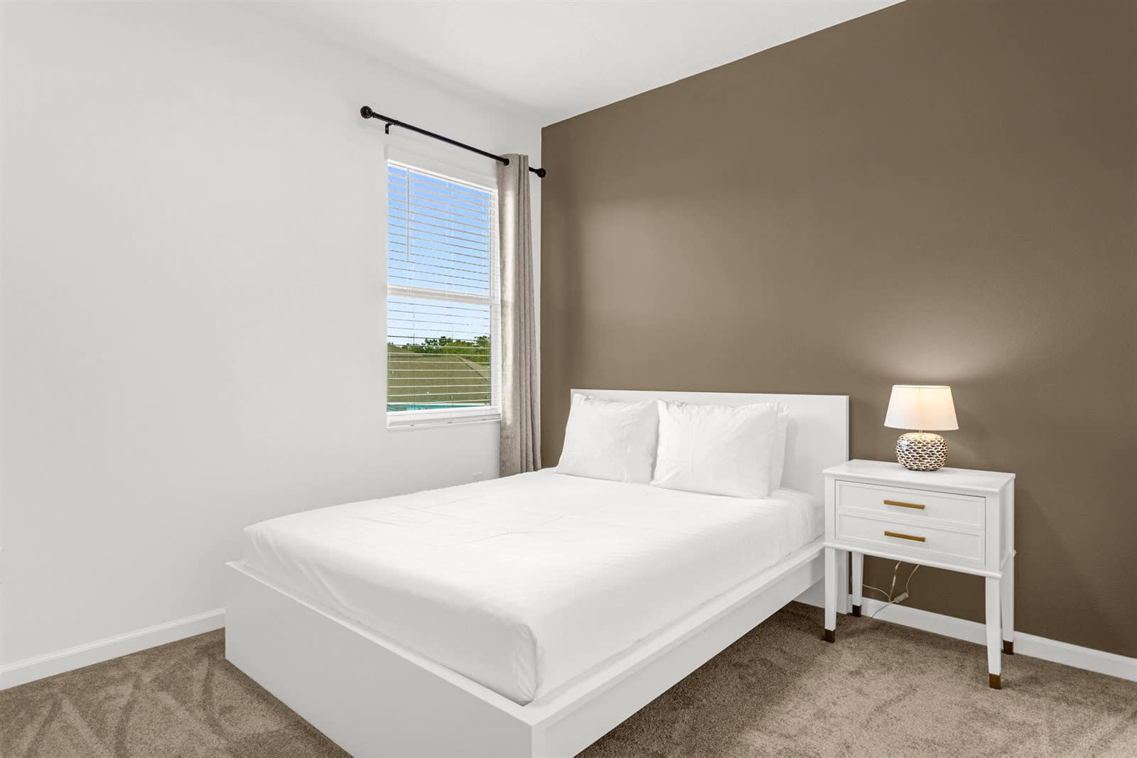 Comfortable Queen Bed With Neutral Tones And Natural Light