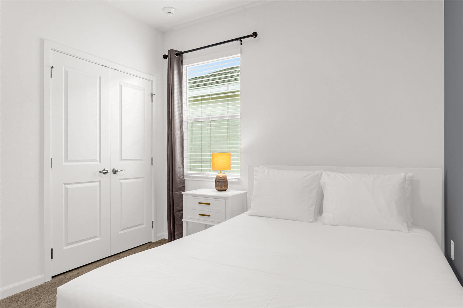 Queen Bedroom With A Clean White Aesthetic And Ample Lighting