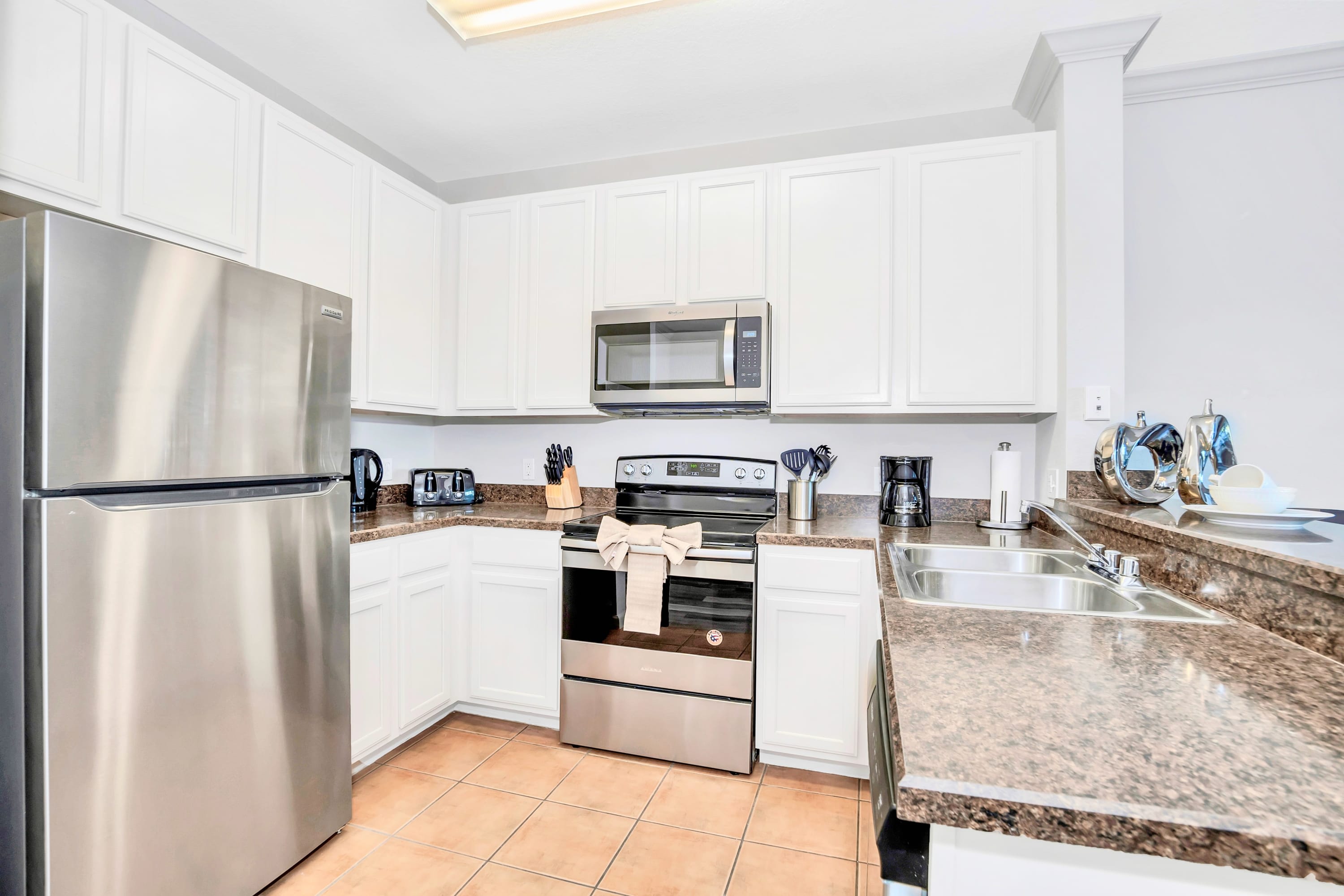 Fully Equipped Kitchen Featuring Stainless Steel Appliances And Granite Countertops
