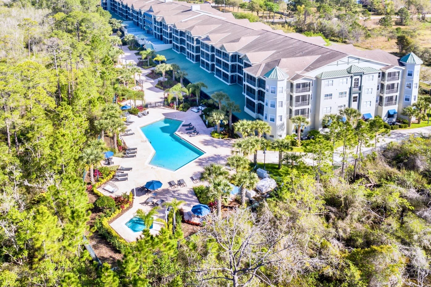 Aerial View Of The Resort-Style Complex Featuring A Large Pool And Serene Surroundings