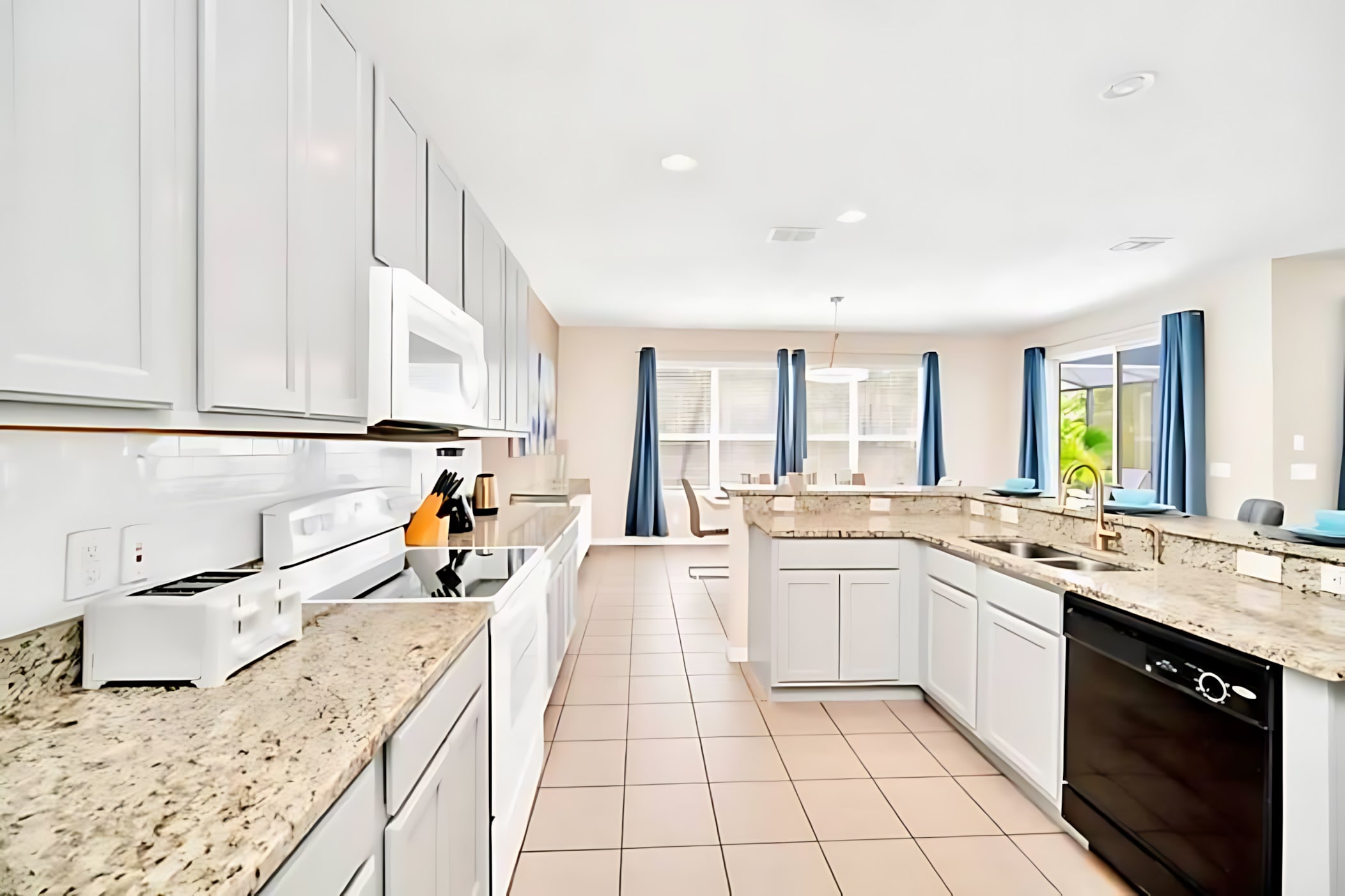 Fully Equipped Kitchen With Stainless Steel Appliances And Granite Countertops