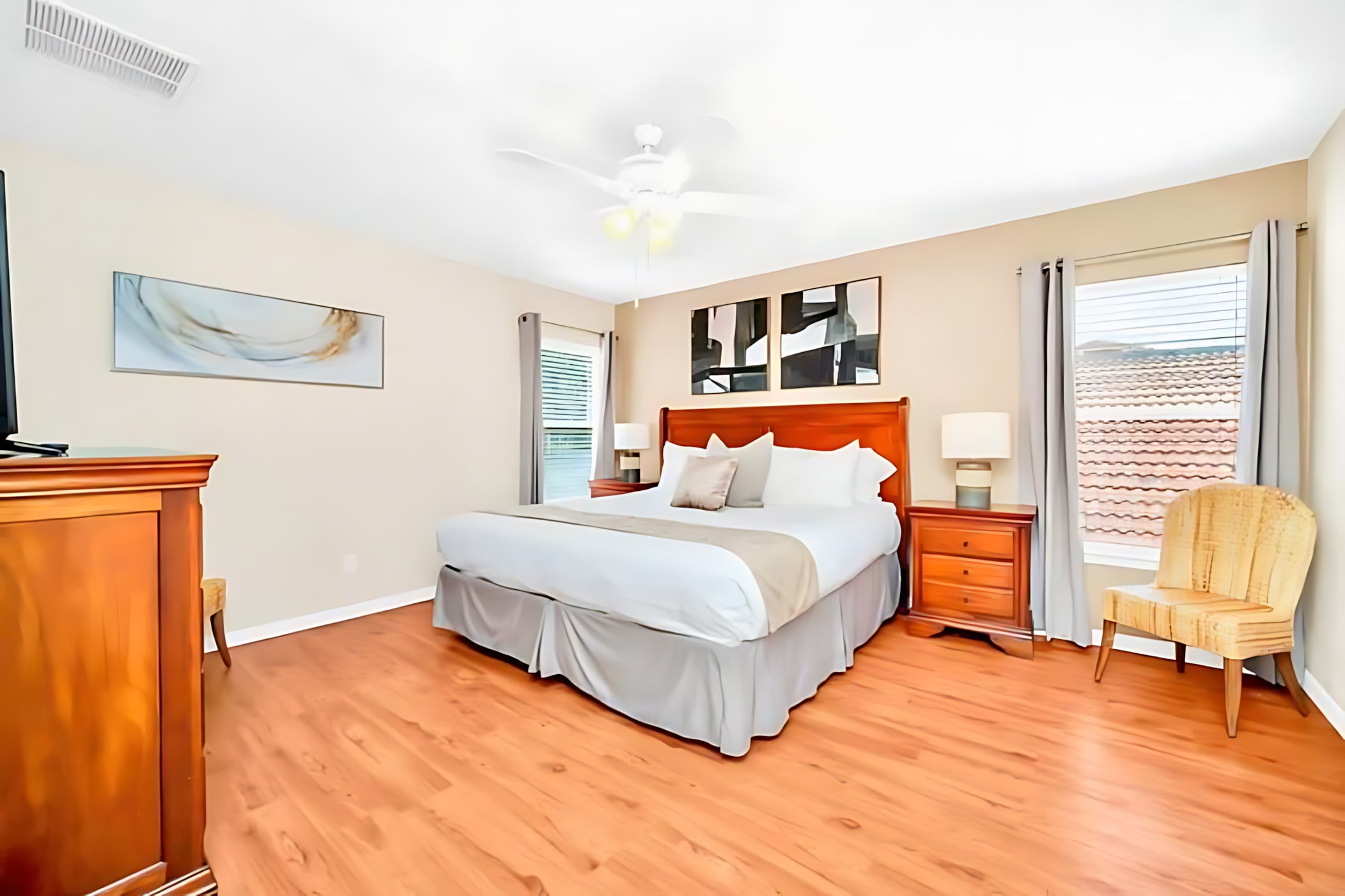 Master Bedroom With King Bed And Warm Wood Floors