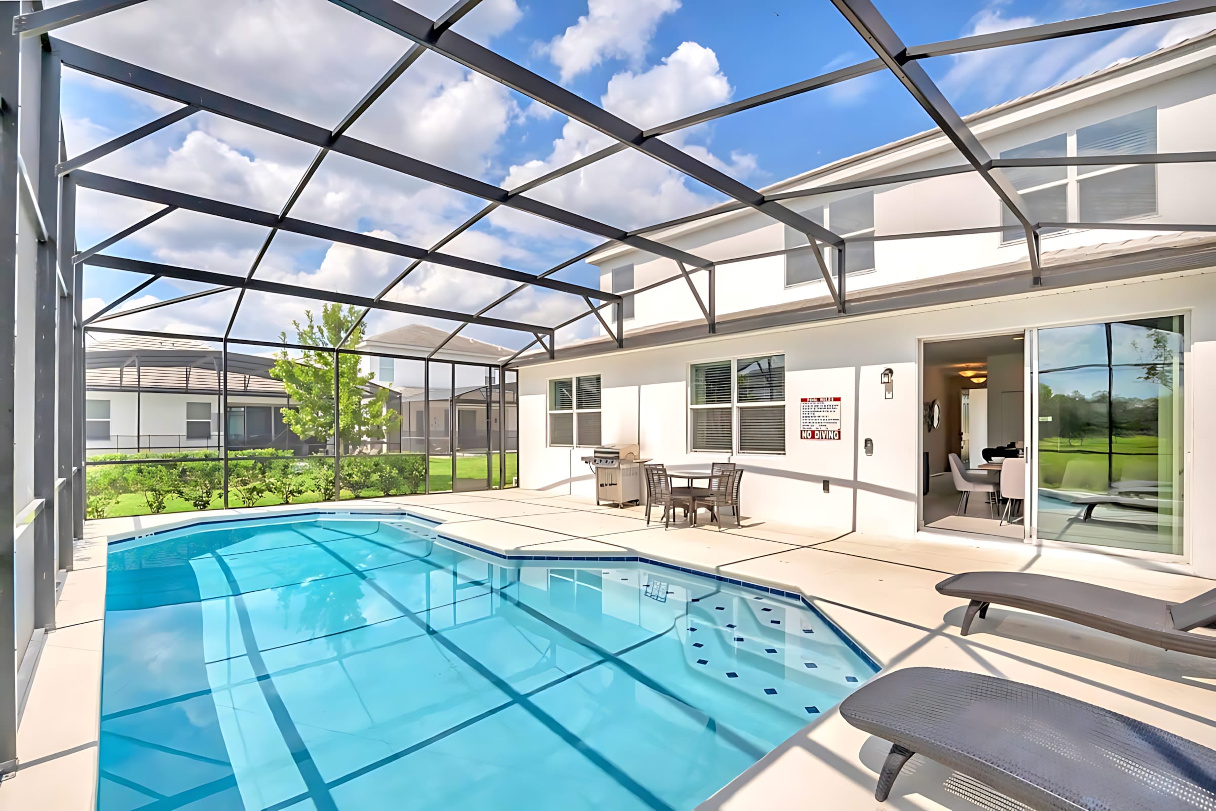 Sun-drenched Patio with Swimming Pool and Poolside Dining Area