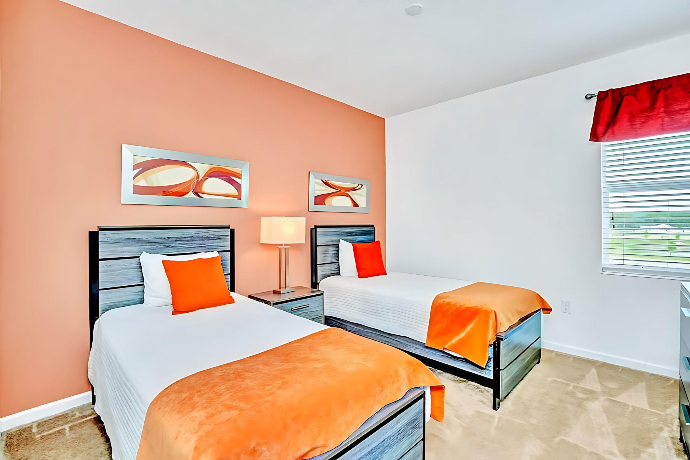 Vibrant Twin Bedroom With Bold Orange And Red Accents