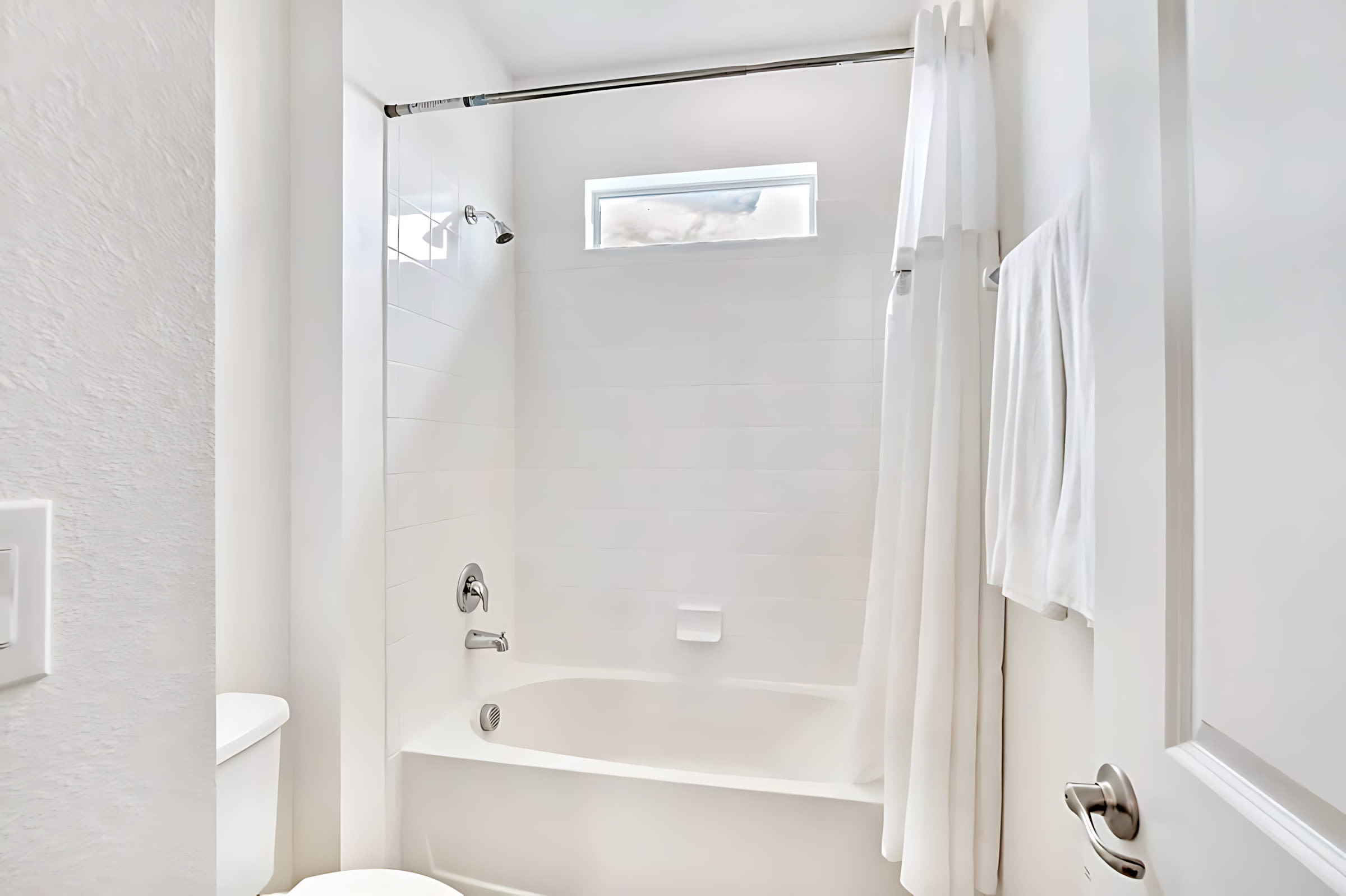 Modern Bathroom With Shower-Tub Combination And Bright Lighting